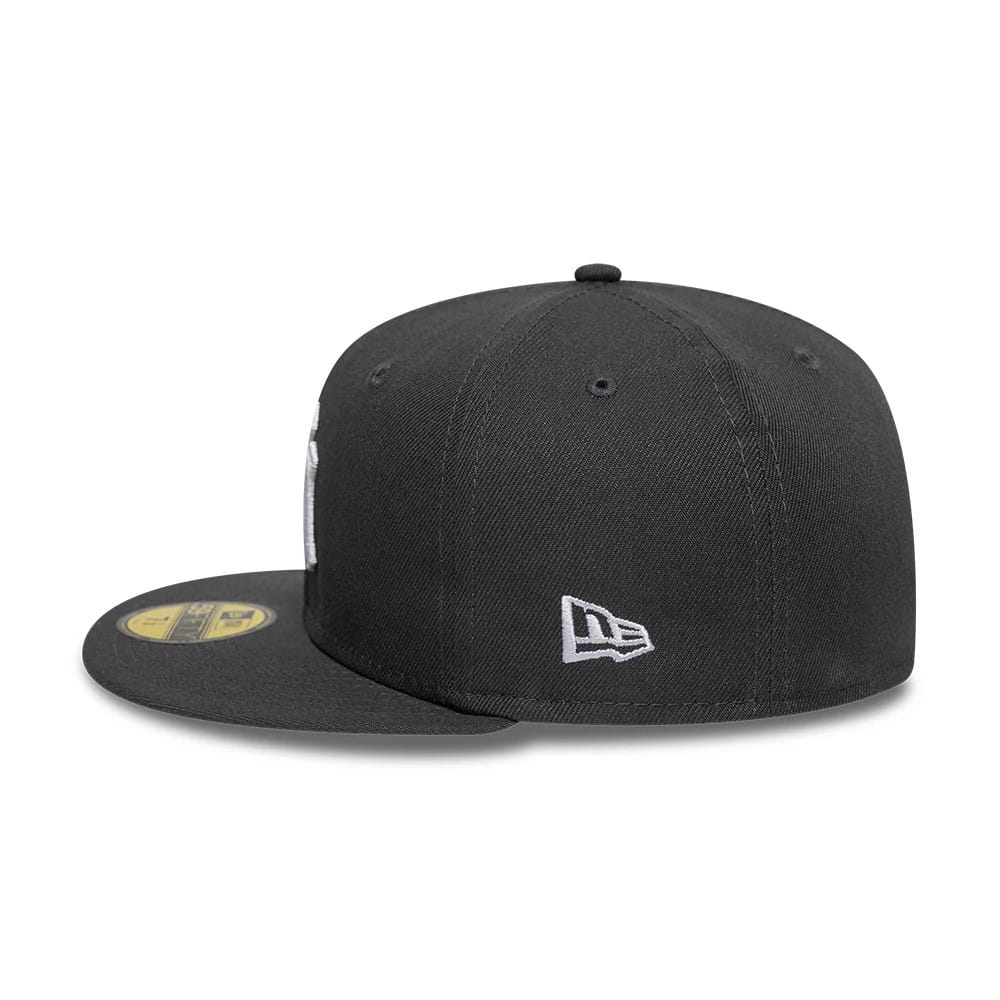 New York Yankees Essential Grey New Era 59FIFTY Fitted Cap, side view showing the embroidered white New Era flag logo on the left side of the grey structured crown and a gold 59FIFTY size sticker on the visor.