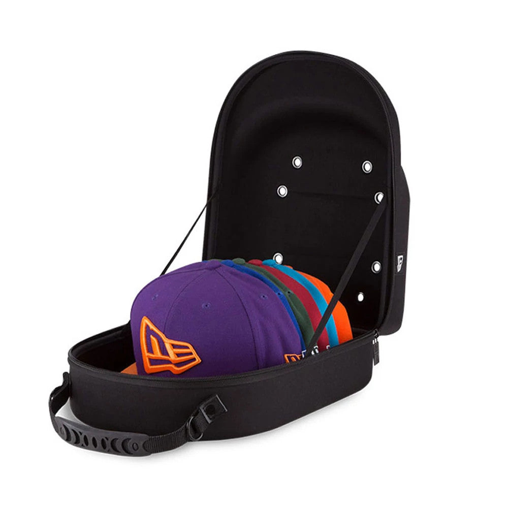 New Era 6 Pack Black Cap Carrier, open view showing the lid with eyelets lifted back, six caps in different colours stacked inside, a raised logo on a purple cap, and a carry handle attached to the base.