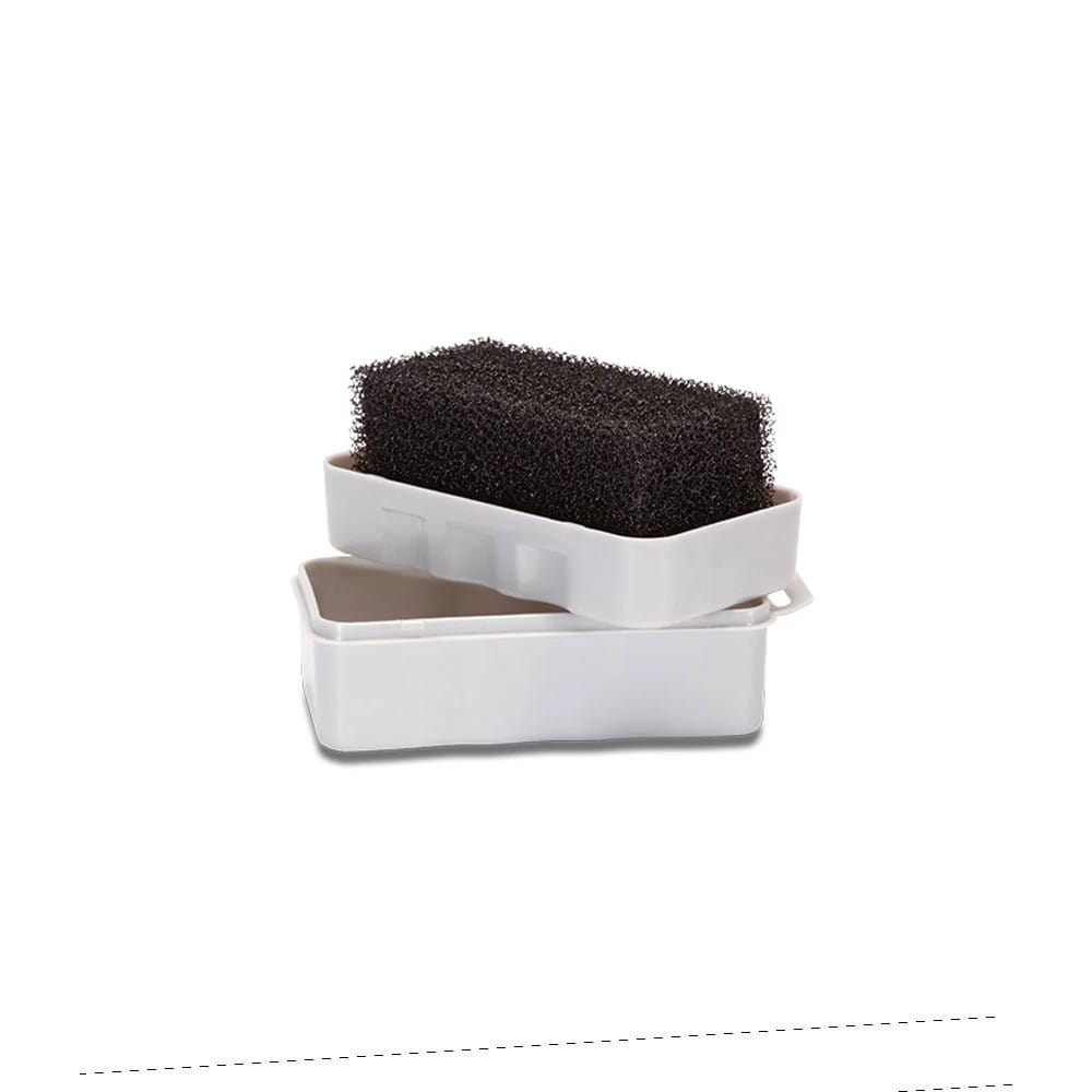 New Era Cap Brush, close-up showing a black textured scrub sponge resting partially in a white rectangular plastic case with a lowered lid, designed for cleaning and maintaining cap surfaces effectively.