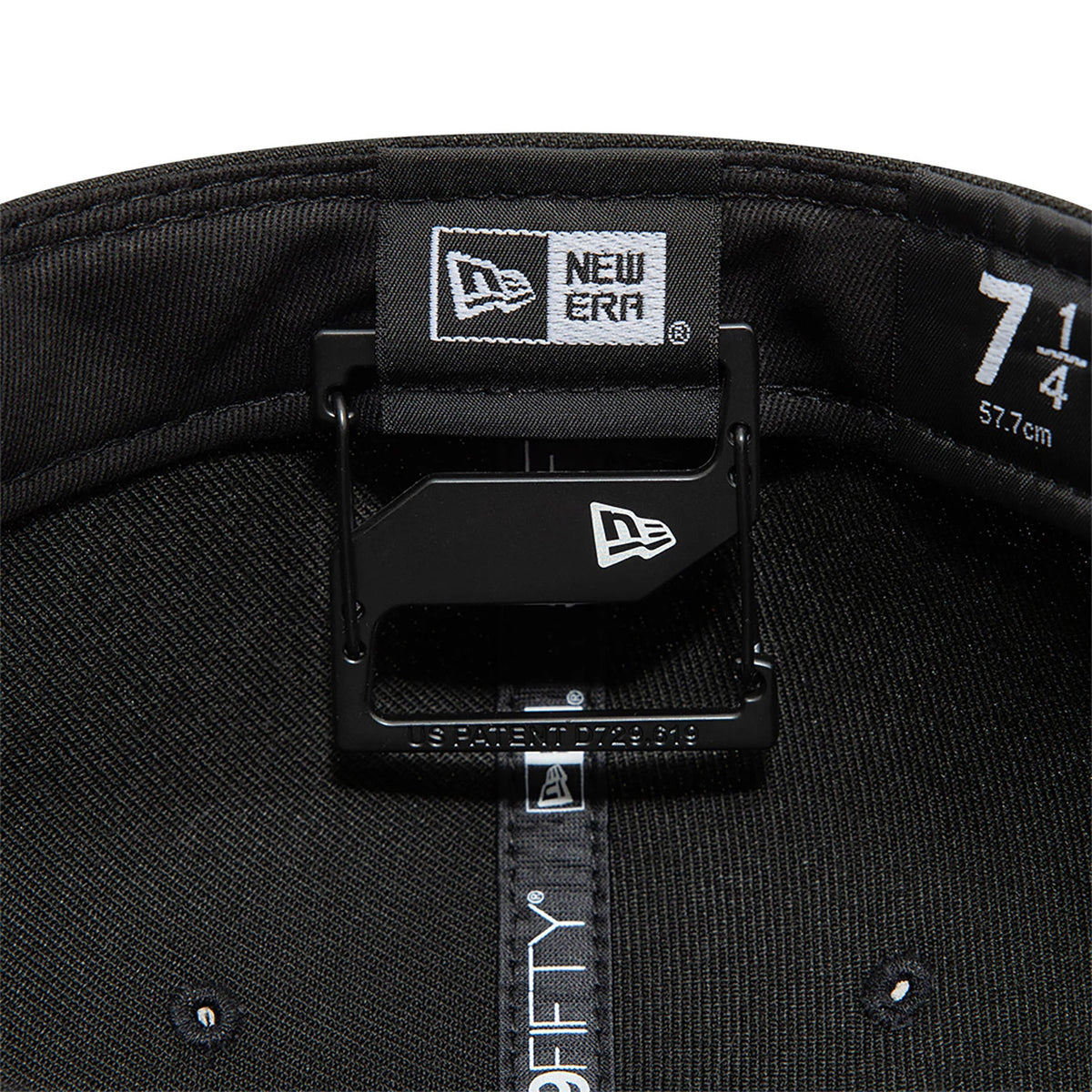 New Era Black Cap Clip, inside view showing the clip attached to the inner sweatband of a black cap, with the New Era flag logo on the clip and label, above size details on the taping strip.