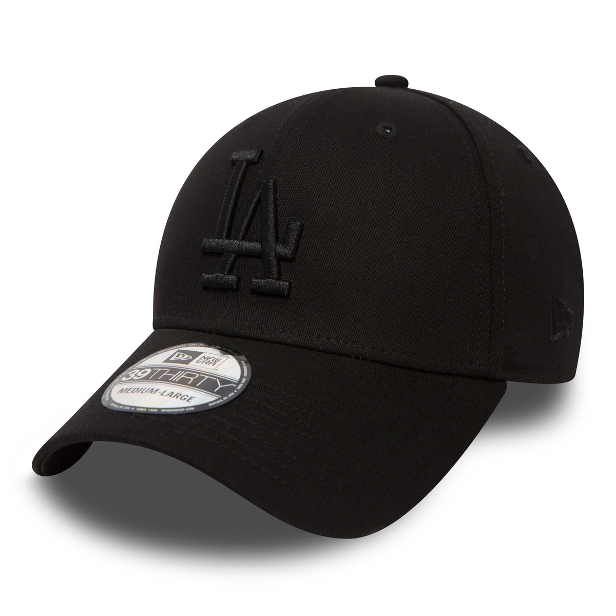 LA Dodgers Essential Black On Black New Era 39THIRTY Cap, three-quarter view showing raised black LA embroidery on the front panel, a black curved visor with a 39THIRTY size sticker, and the New Era flag logo on the left side.