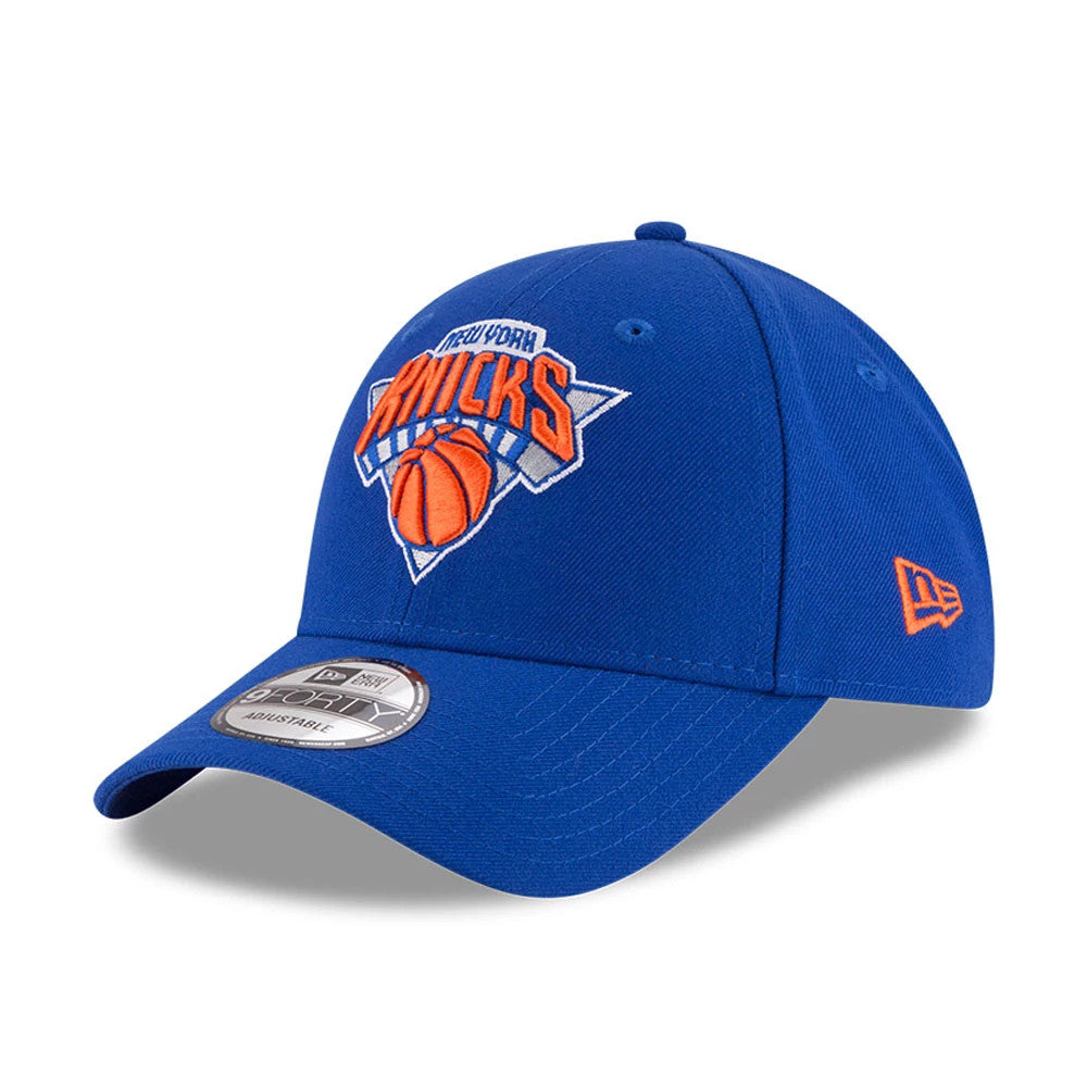 New York Knicks The League Blue New Era 9FORTY Cap, three-quarter view showing the orange and white embroidered logo on the front panel, with a 9FORTY size sticker on the curved blue visor and New Era flag logo on the left side.