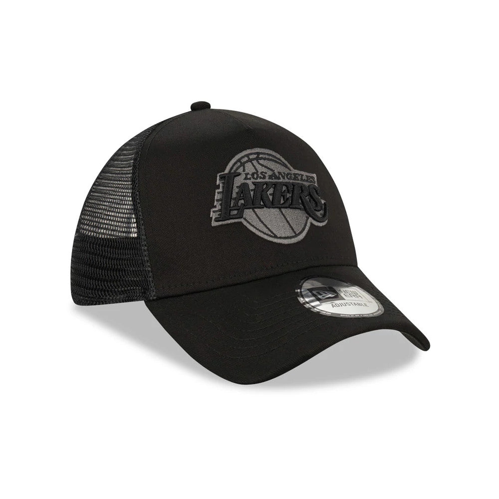 LA Lakers Tonal Black New Era A-Frame Trucker Cap, three-quarter view showing a grey embroidered Lakers front panel logo, black mesh side panels, and a 9FORTY size sticker on the curved black visor.