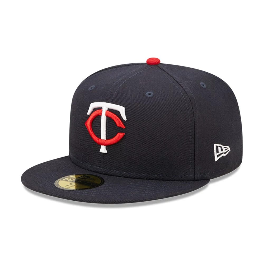 Minnesota Twins Authentic On Field Navy New Era 59FIFTY Cap, three-quarter view showing the raised red and white embroidered TC logo on the front panel, navy flat visor with gold 59FIFTY size sticker, and the New Era flag logo on the left side.