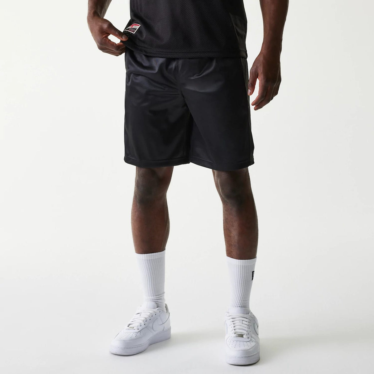 The Male model is wearing New Era Retro Sports Black Mesh Shorts 1