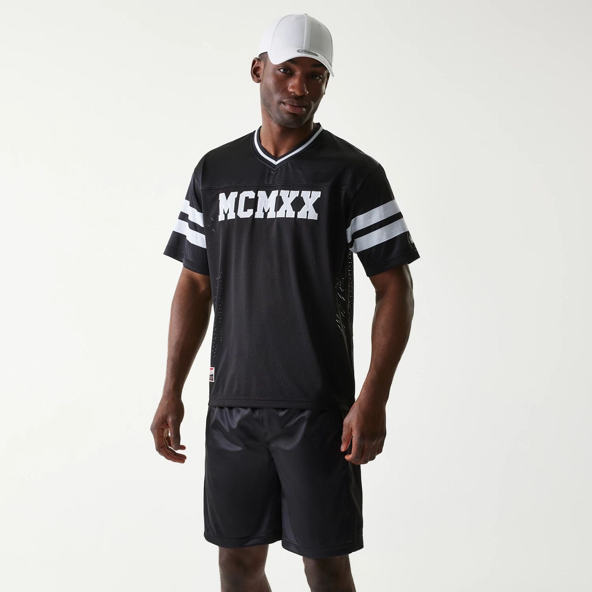 The Male model is wearing New Era Retro Sports Black Mesh Jersey 1
