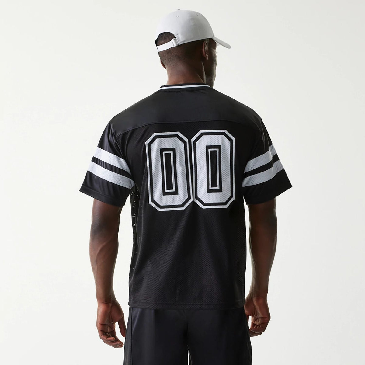 New Era Retro Sports Black Mesh Jersey, back view on a model wearing a white cap, showing '00' lettering centred on the back with white double stripes on the sleeves and a V-neck collar design.