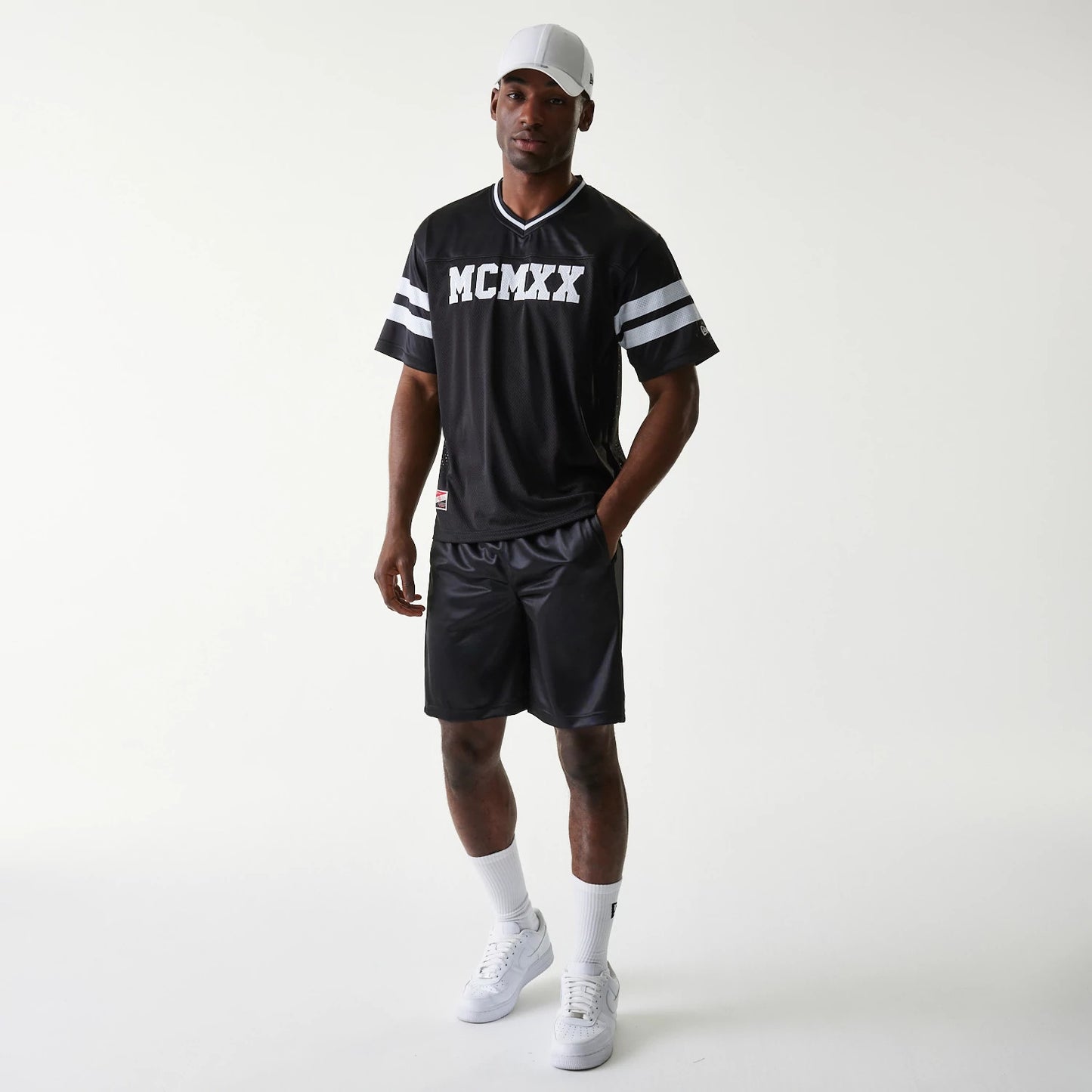 The Male model is wearing New Era Retro Sports Black Mesh Jersey 8