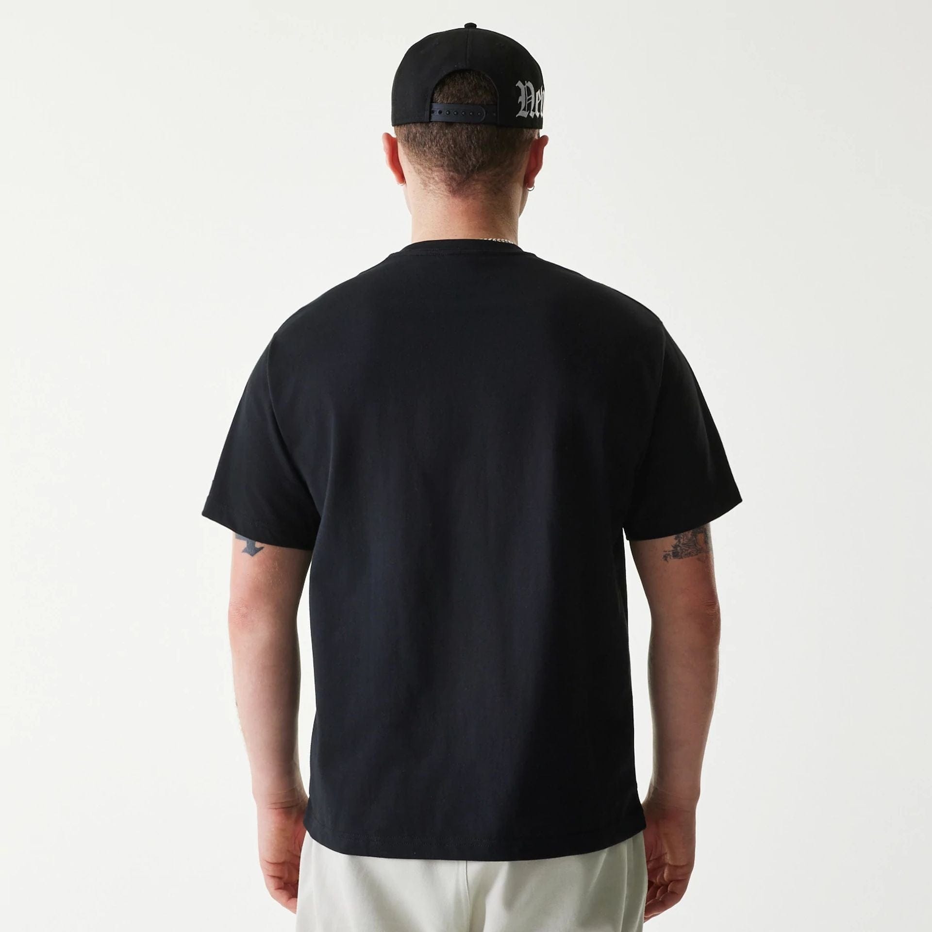 The Male model is wearing New Era Peace Symbol Black T-Shirt 2