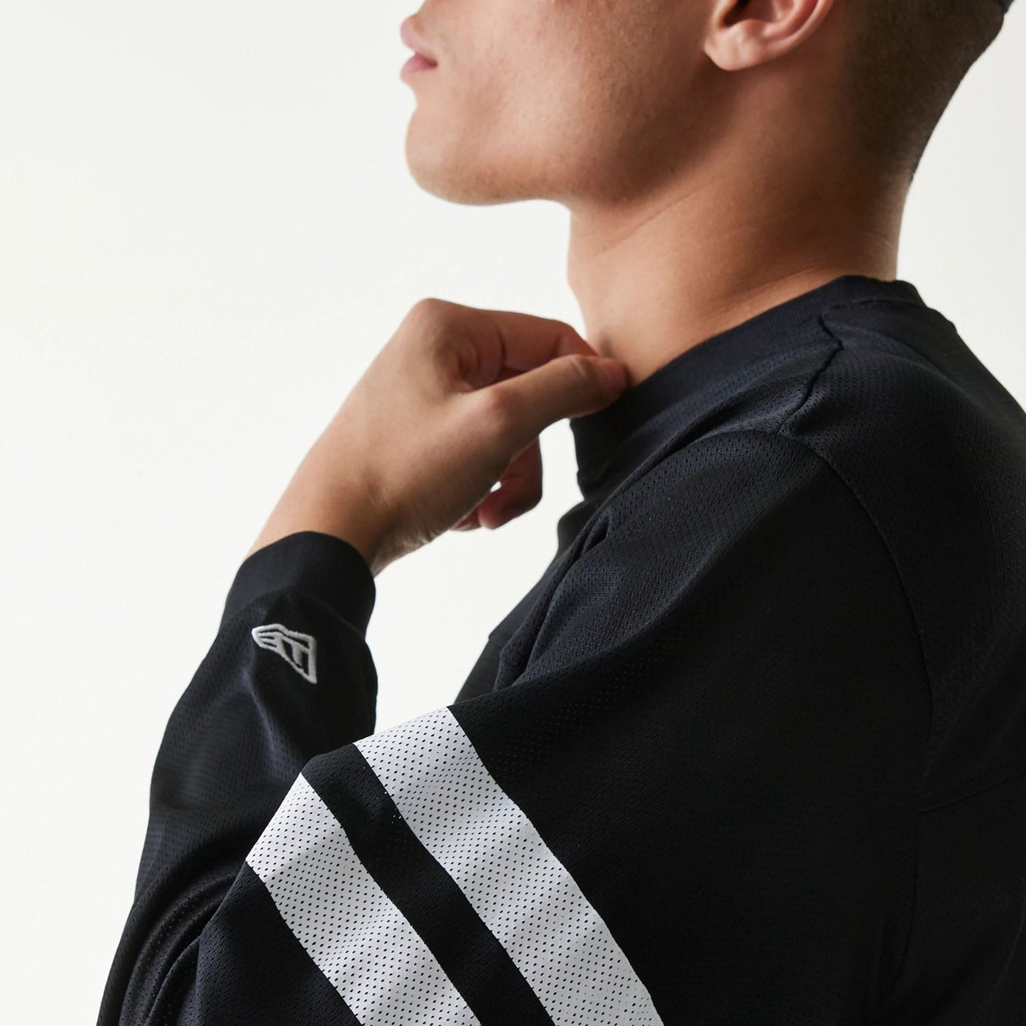 The Male model is wearing New Era Mesh Water Black Long Sleeve T-Shirt 7