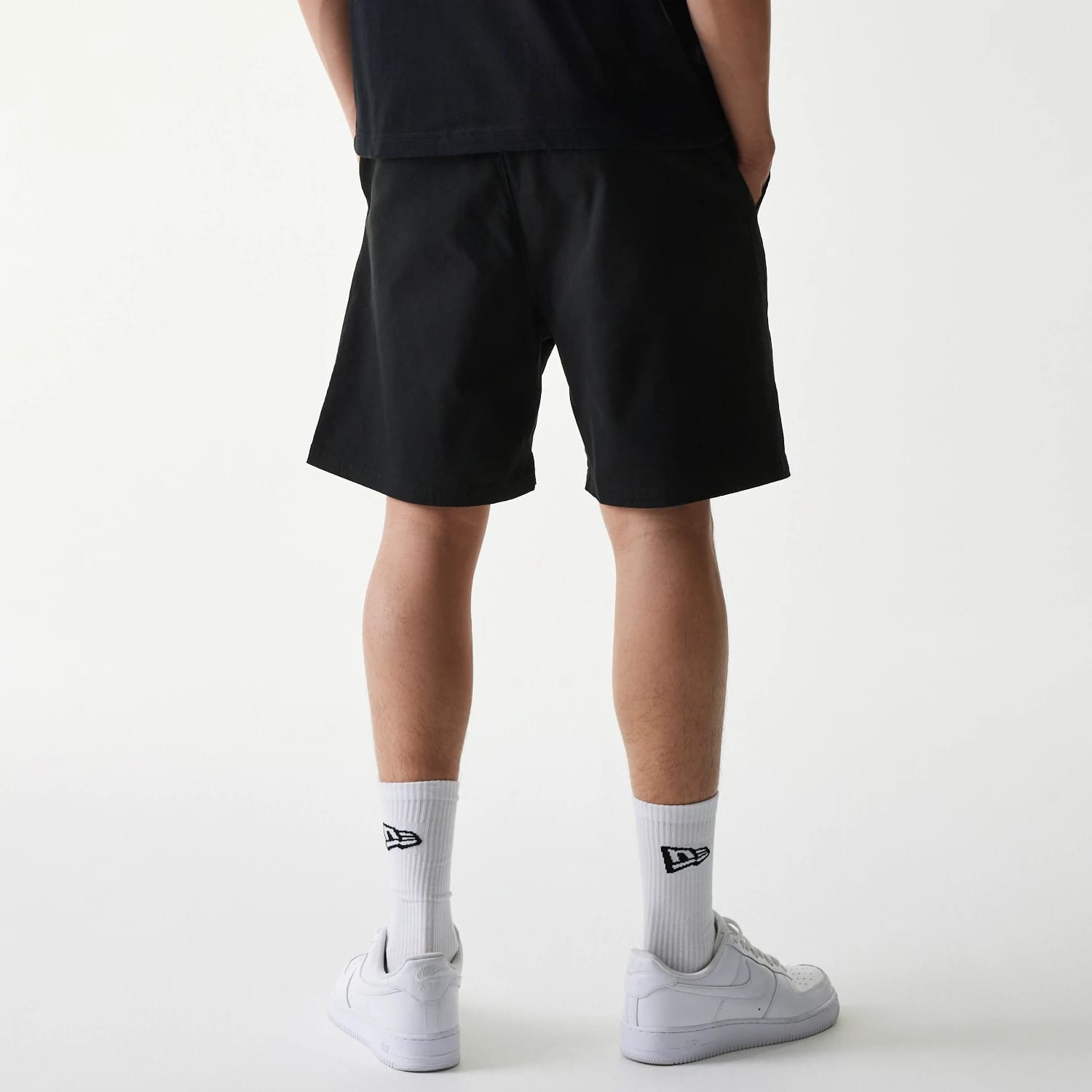 The Male model is wearing New Era Japan Woven Black Shorts 2