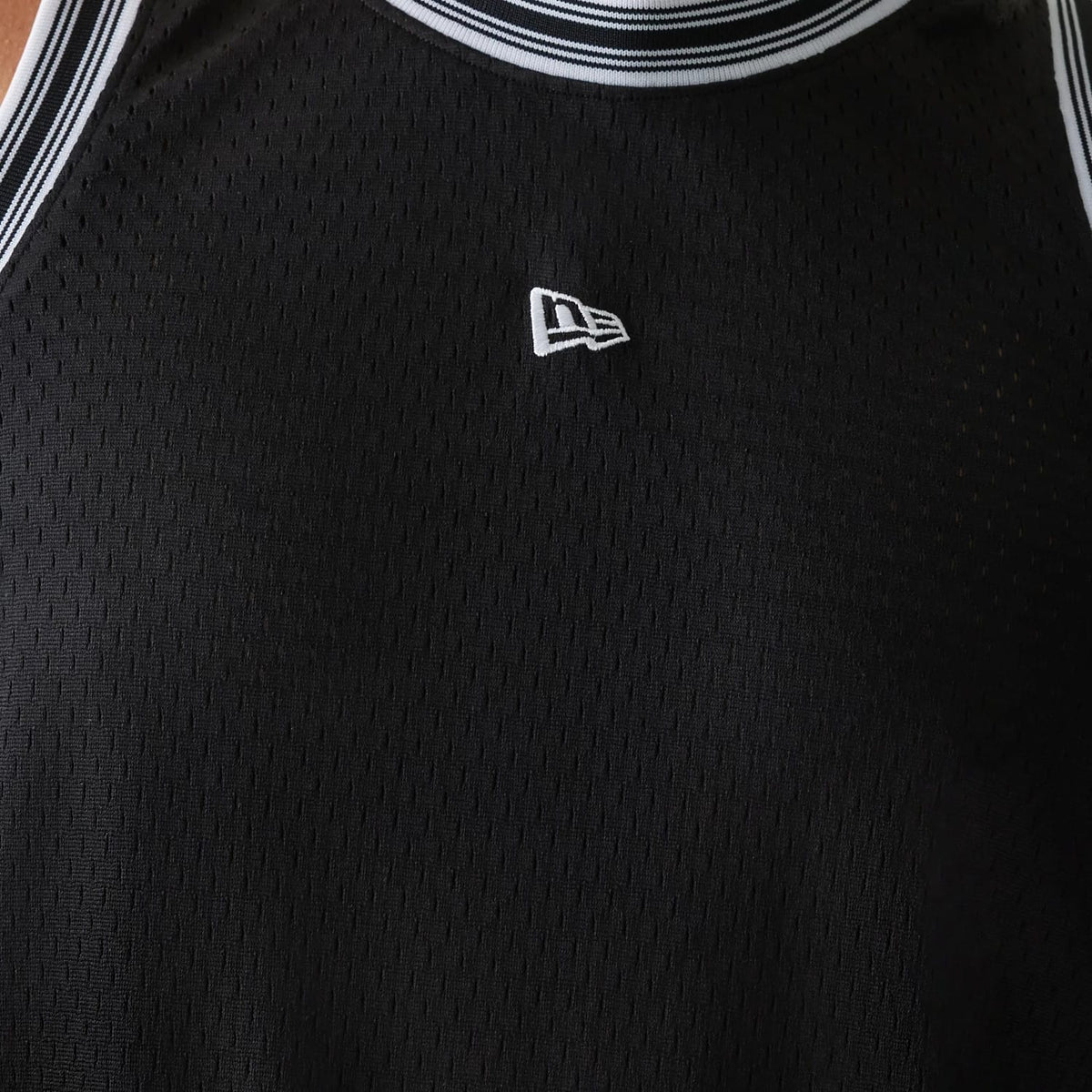 New Era Japan Mesh Black Sleeveless T-Shirt, front view showing a black sleeveless design with a raised white New Era logo centred on the upper chest, and white striped trims along the neckline and arm openings.