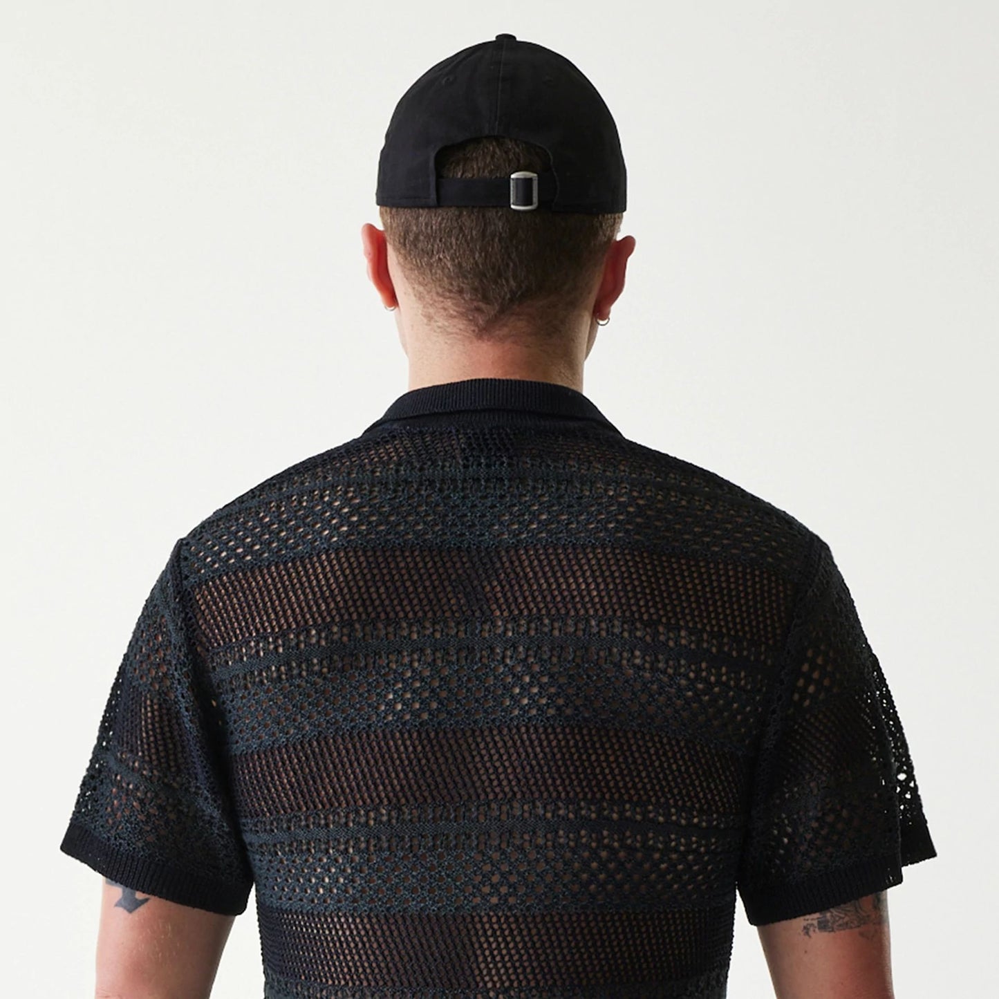 The Male model is wearing New Era Japan Mesh Black Polo T-Shirt 5