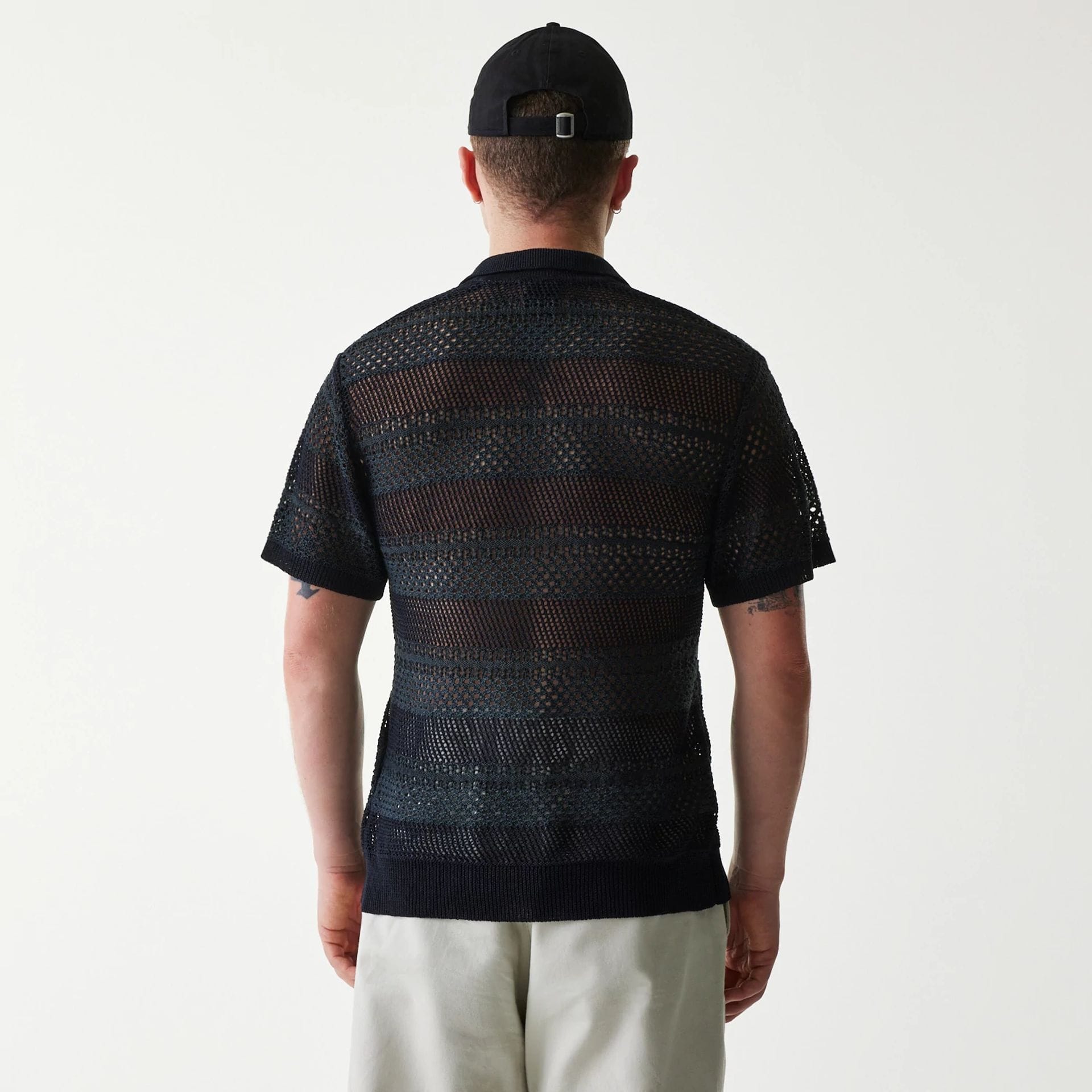 The Male model is wearing New Era Japan Mesh Black Polo T-Shirt 2