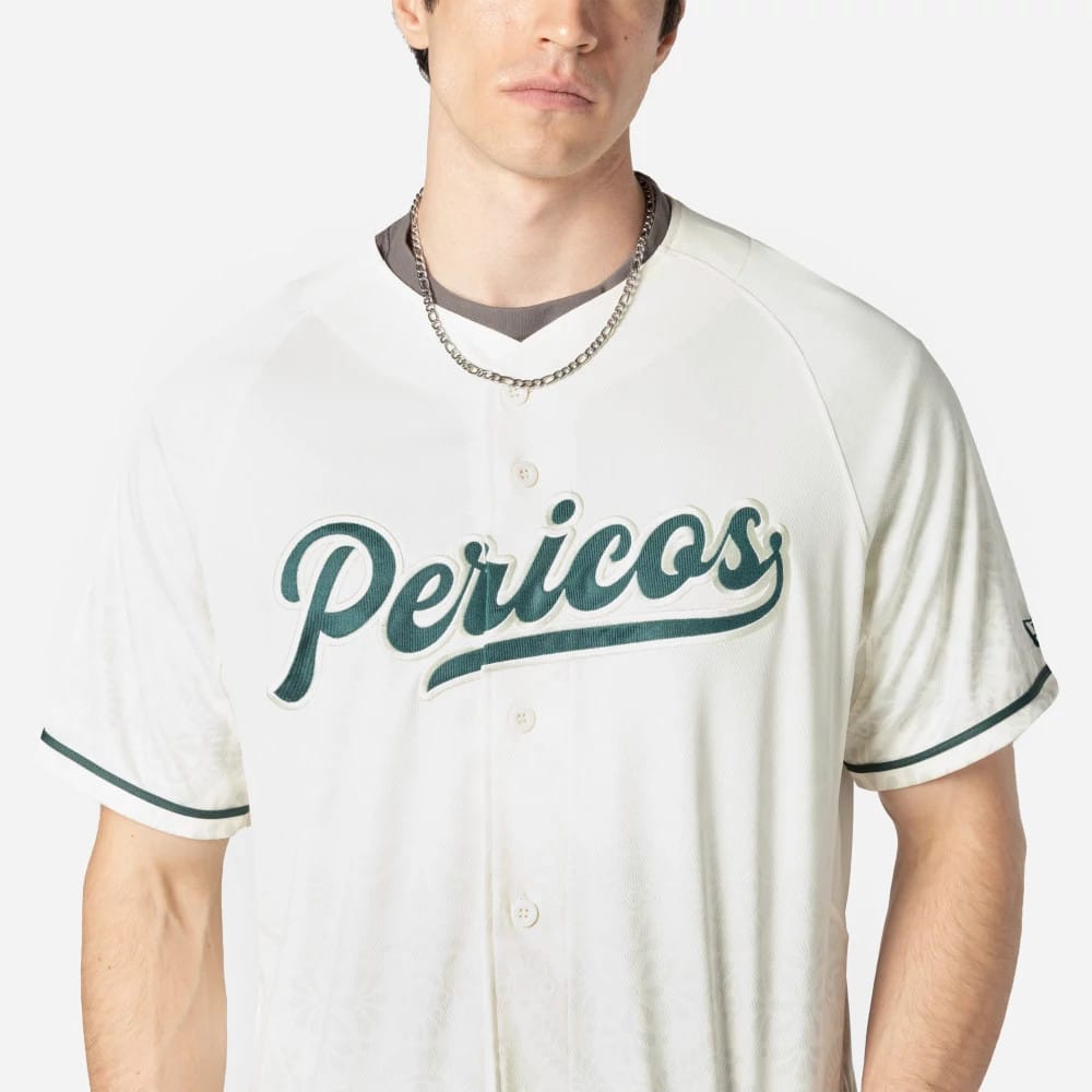 Puebla Pericos Mexico LMB On Field White On-Field Jersey, front view on a model showing the green Pericos script logo embroidered across the chest, with dark green sleeve piping and a New Era flag logo on the left sleeve.