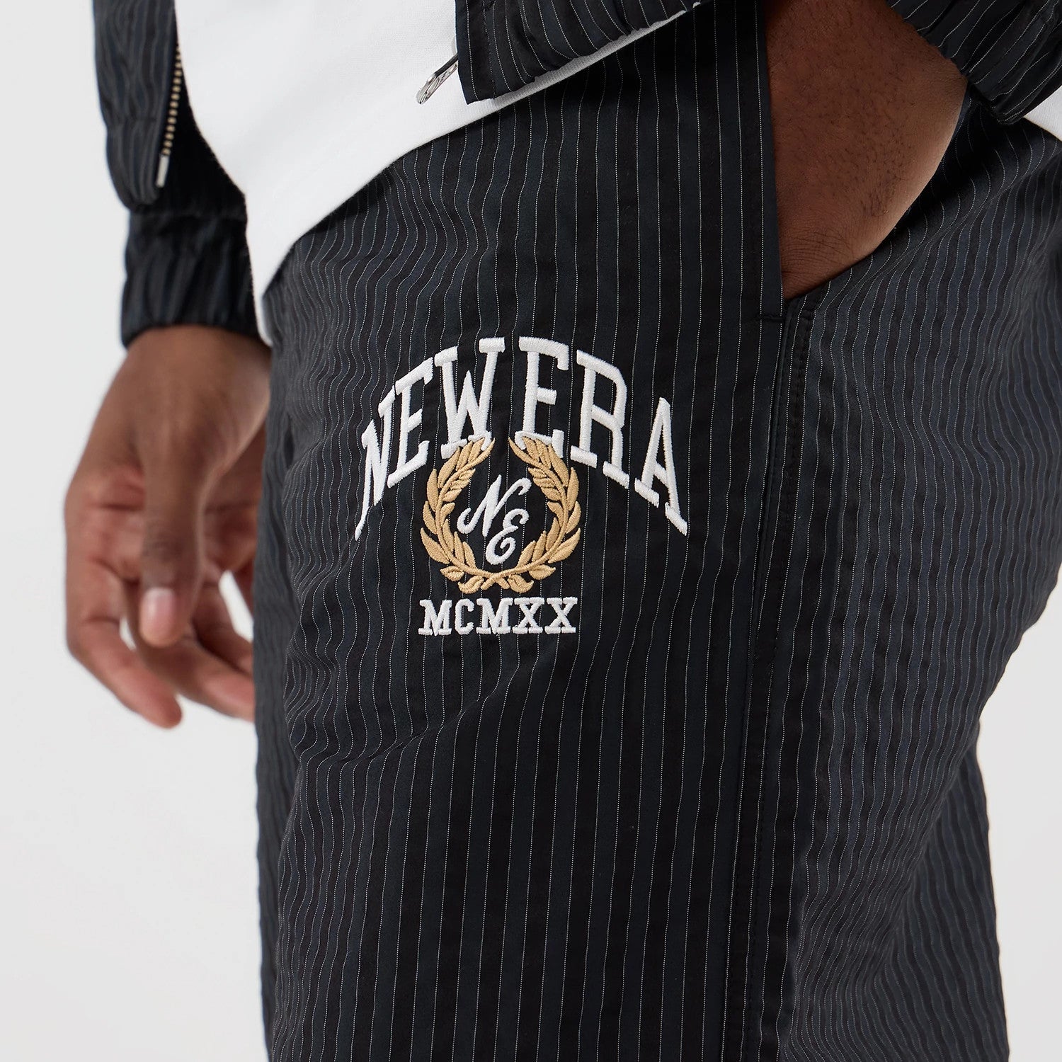 The model is wearing these New Era Street Class straight leg joggers in navy. 2