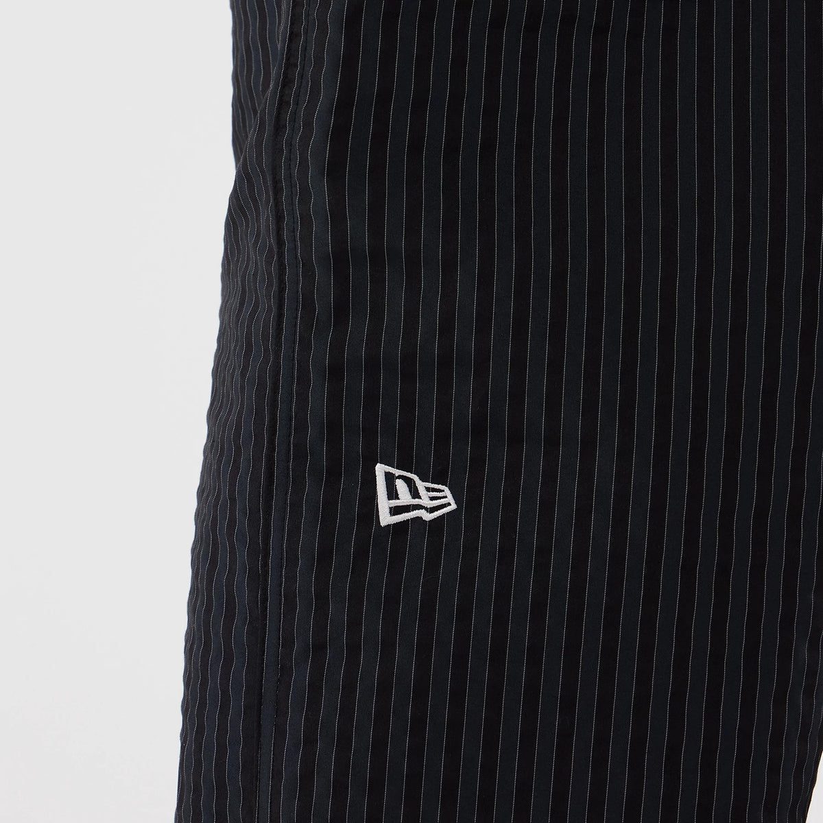 The model is wearing these New Era Street Class straight leg joggers in navy. 3