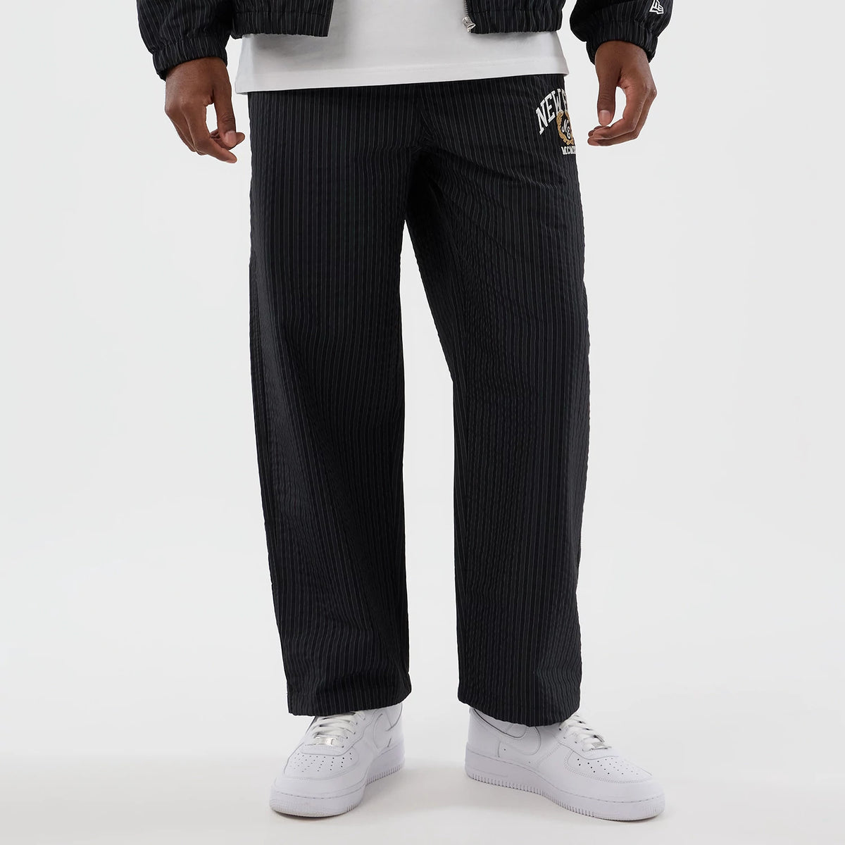 The model is wearing these New Era Street Class straight leg joggers in navy. 8