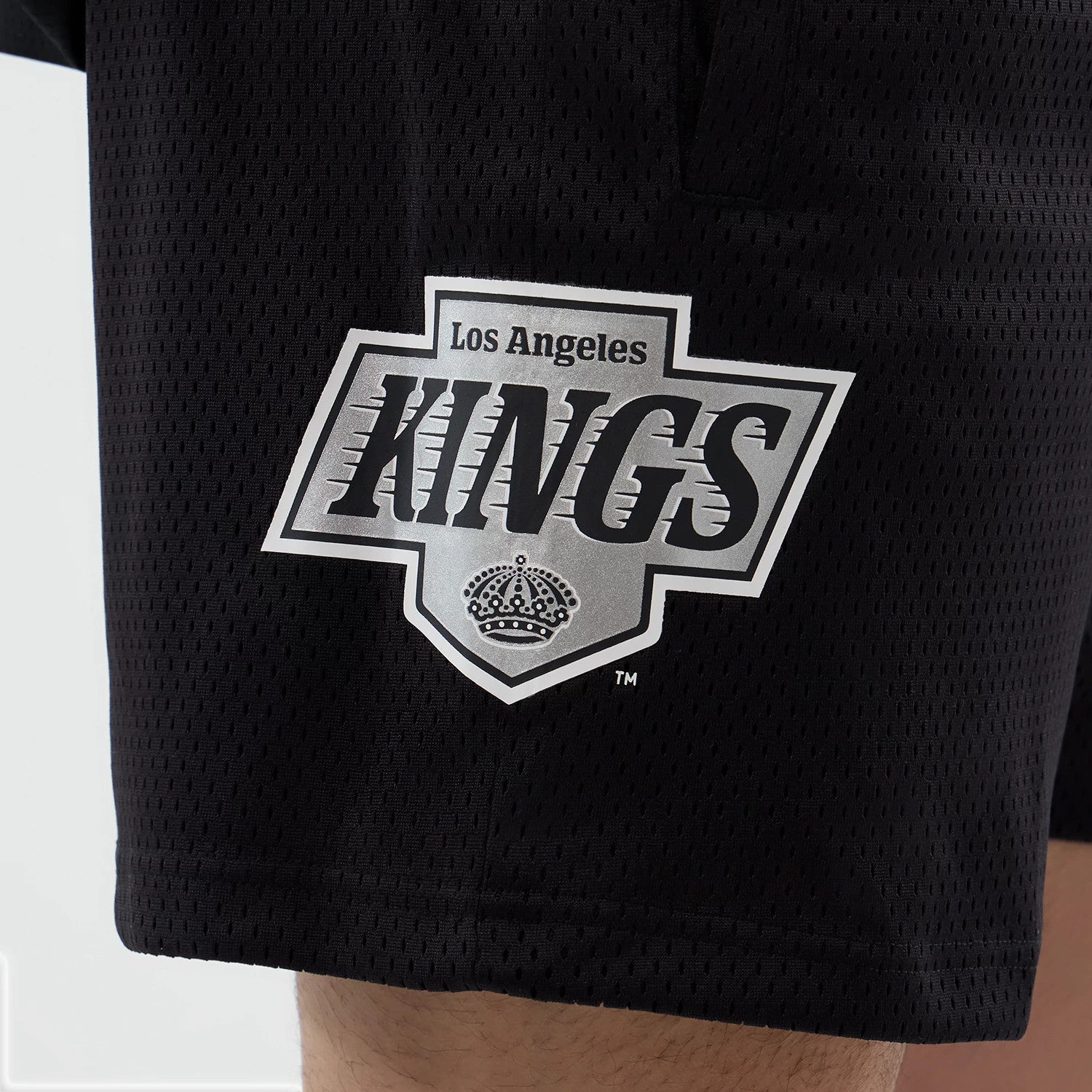 The Male model is wearing LA Kings NHL Street Culture Black Oversized Shorts 4