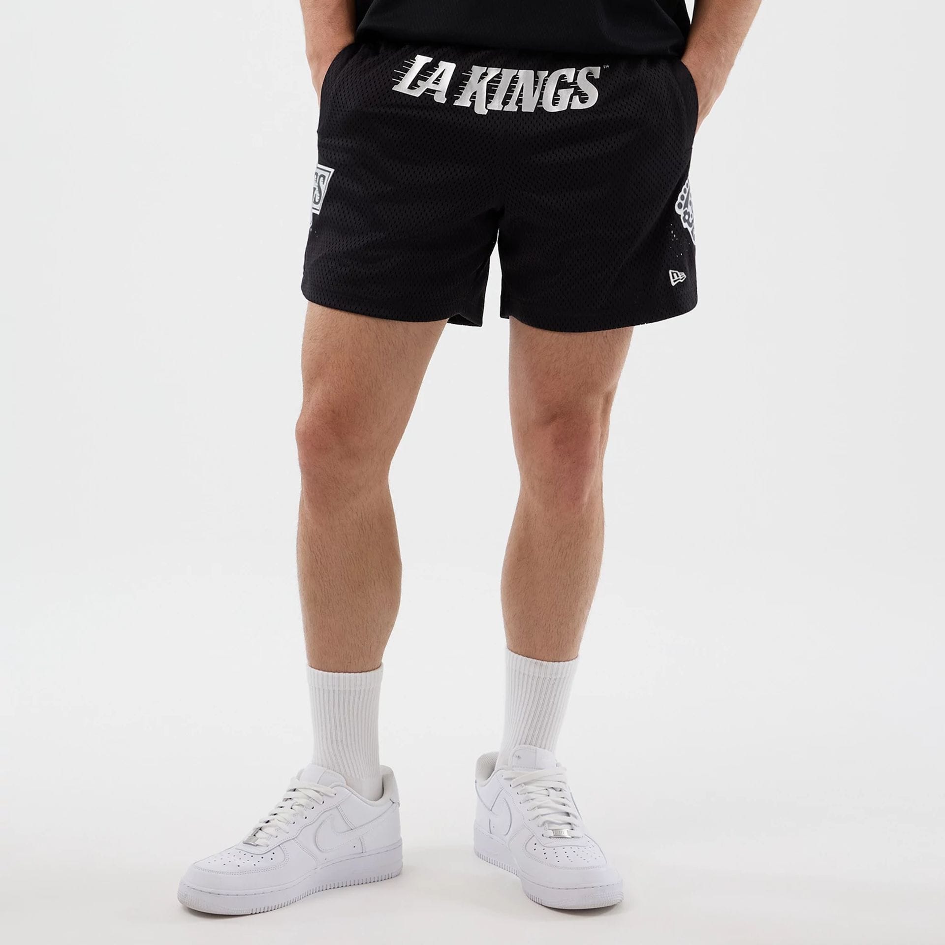 The Male model is wearing LA Kings NHL Street Culture Black Oversized Shorts 1