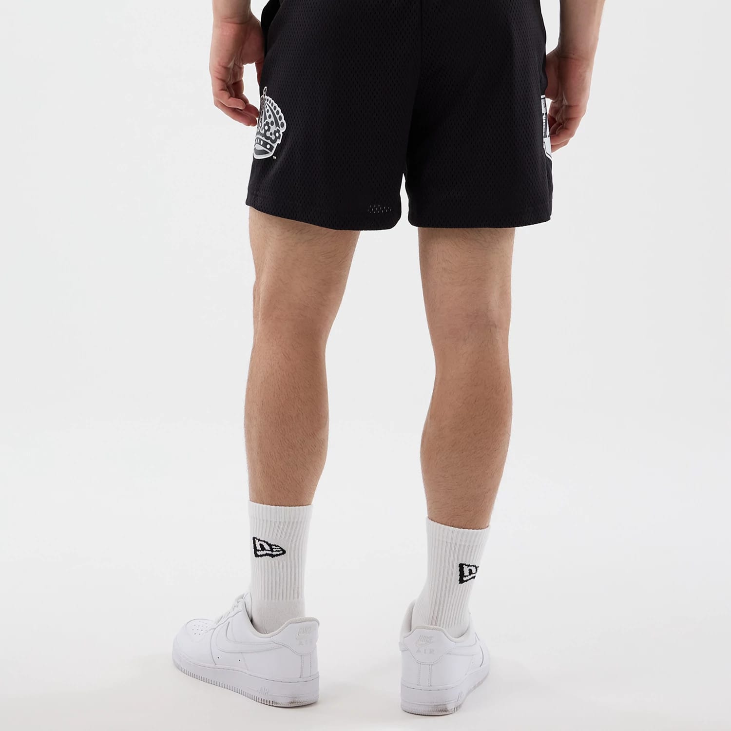 The Male model is wearing LA Kings NHL Street Culture Black Oversized Shorts 2