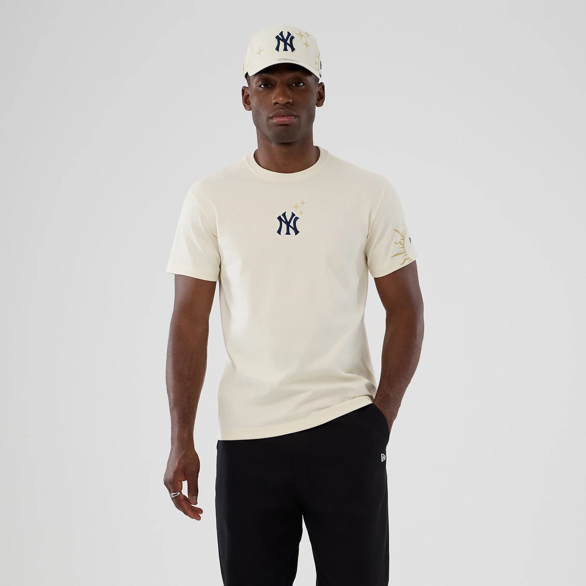 The model is wearing this MLB Cosmic Craft New York Yankees T-Shirt in white. 1