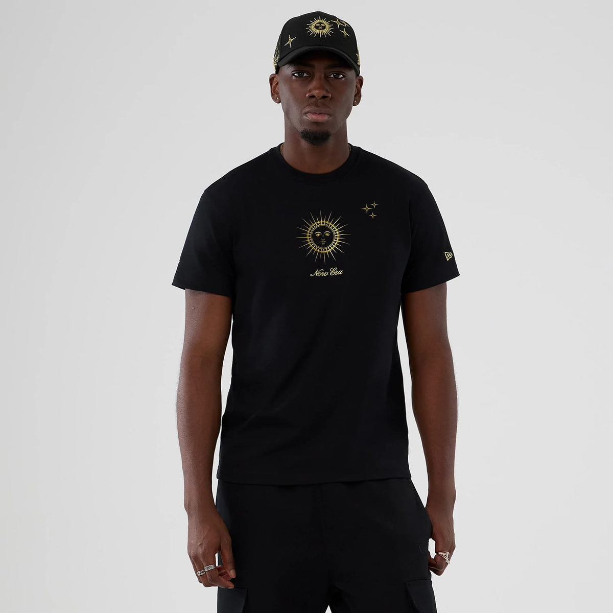 The model is wearing this New Era Cosmic Craft T-Shirt in black. 1
