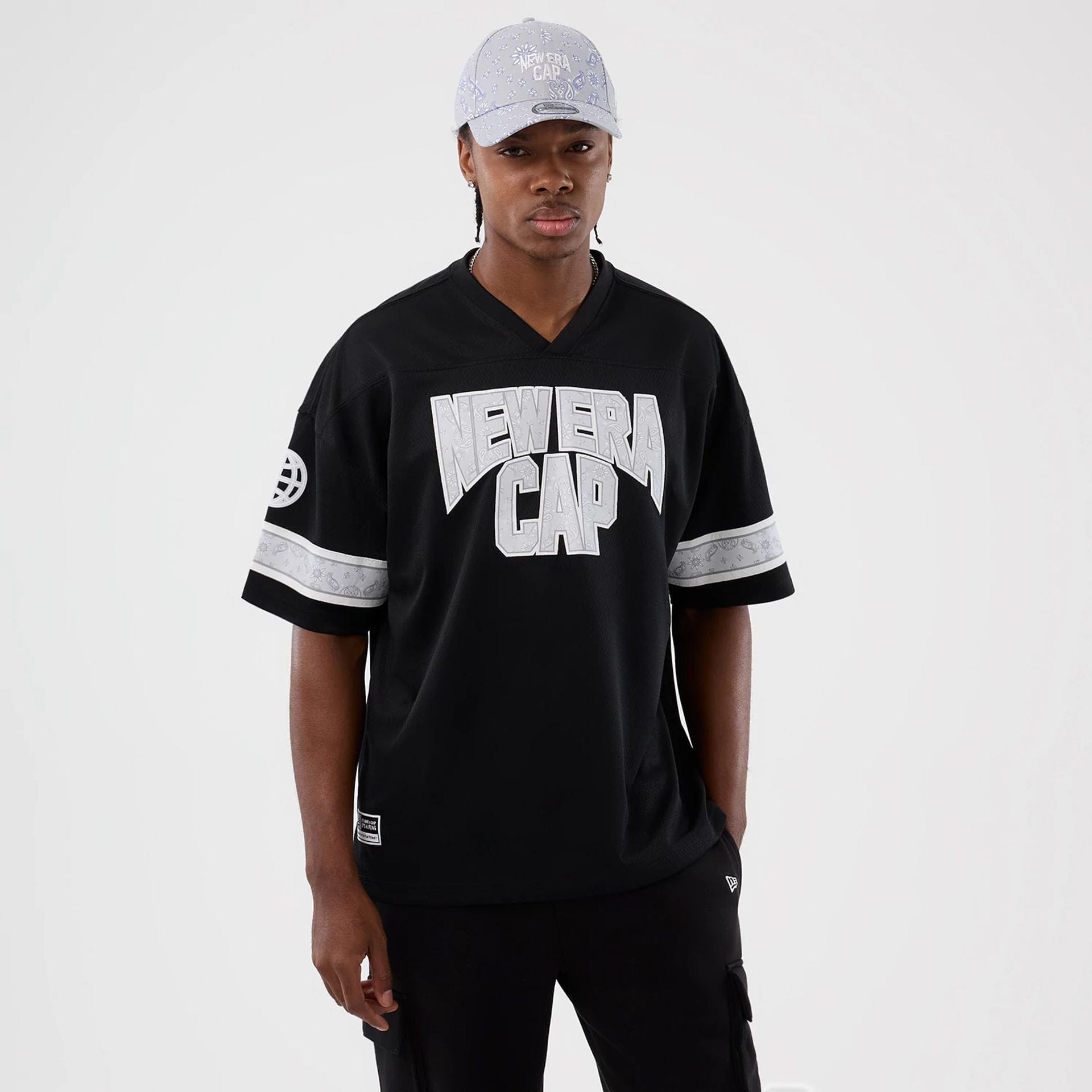 The Male model is wearing New Era Street Swing Black T-Shirt 1