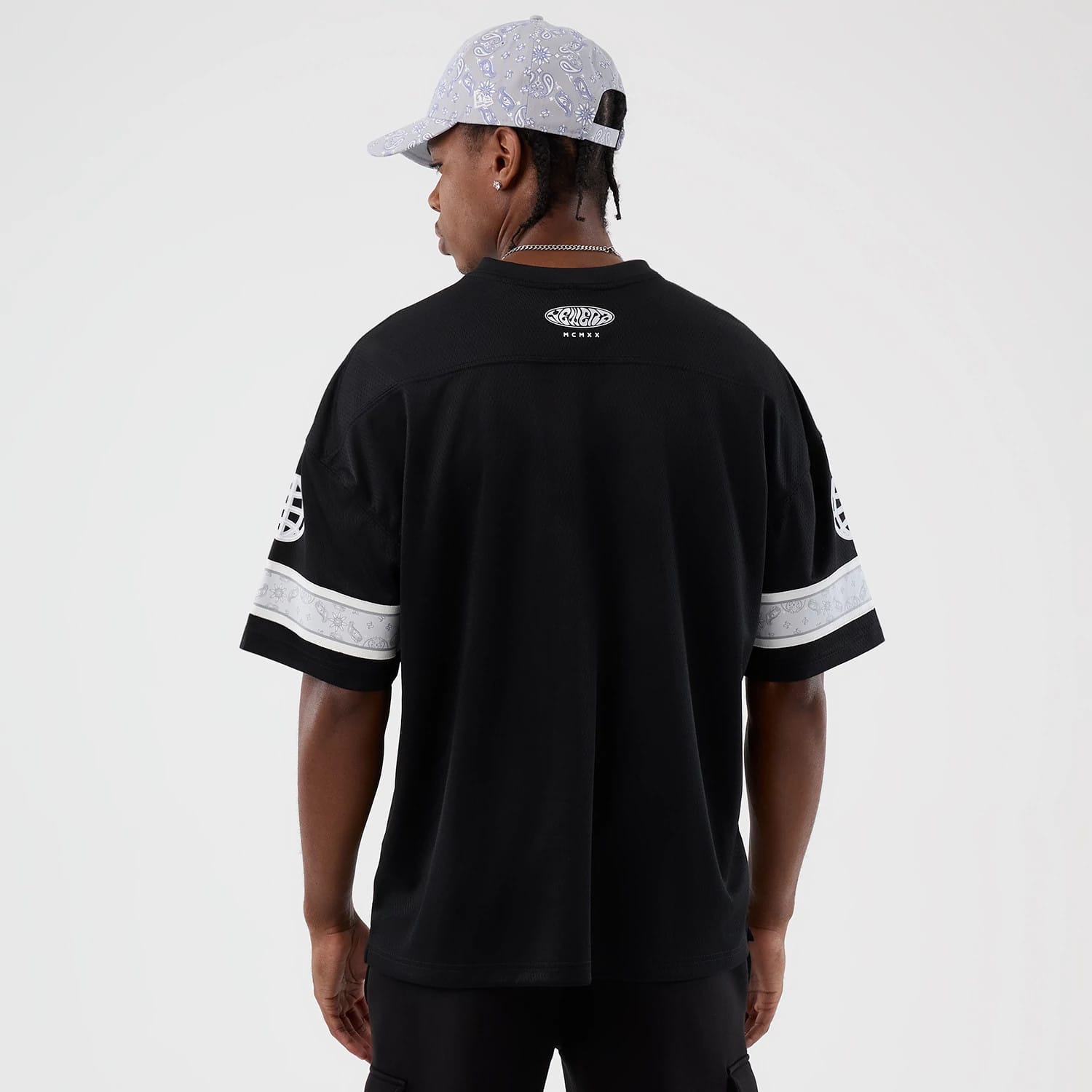 The Male model is wearing New Era Street Swing Black T-Shirt 2