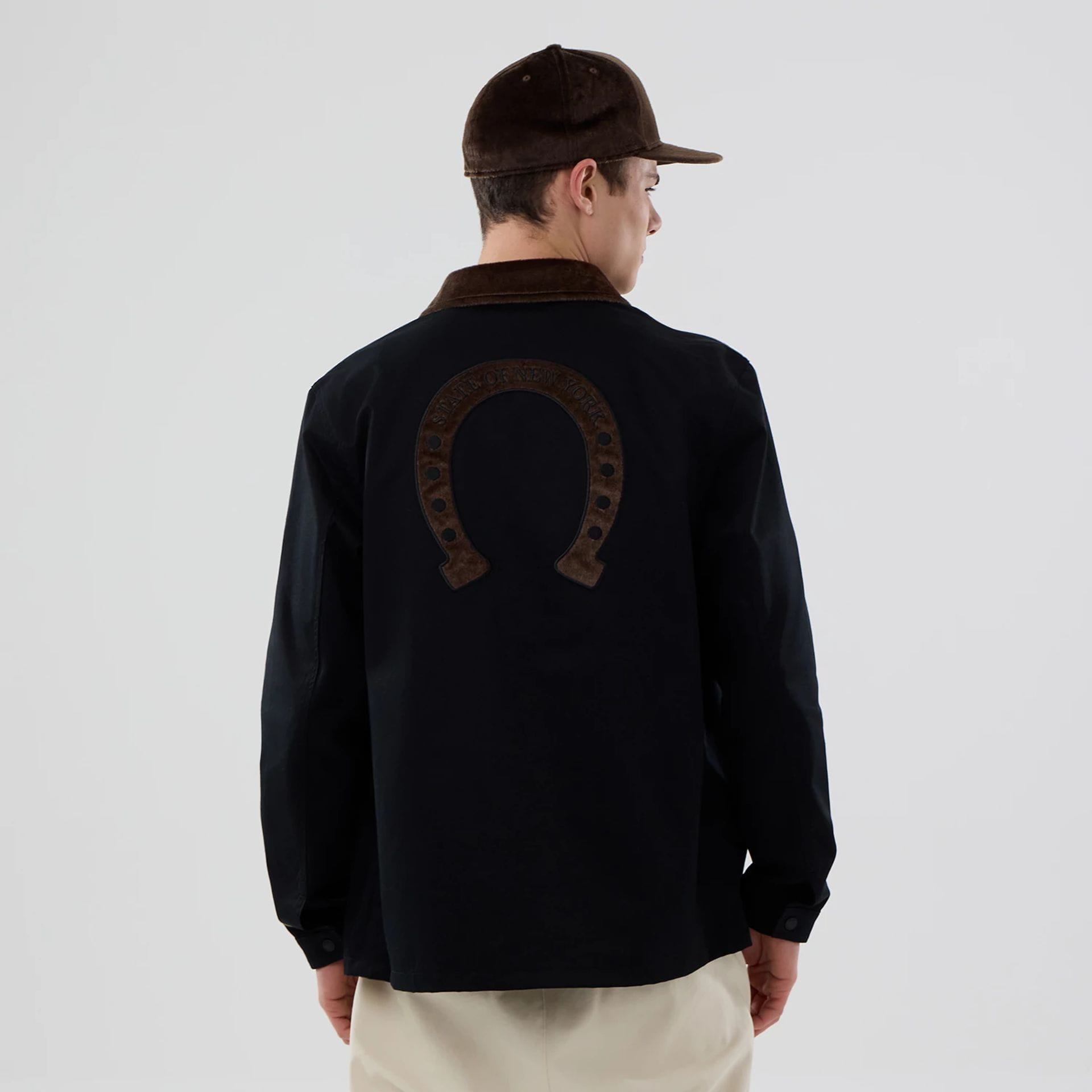 The model is wearing this New Era Year Of The Horse Jacket in black. 2