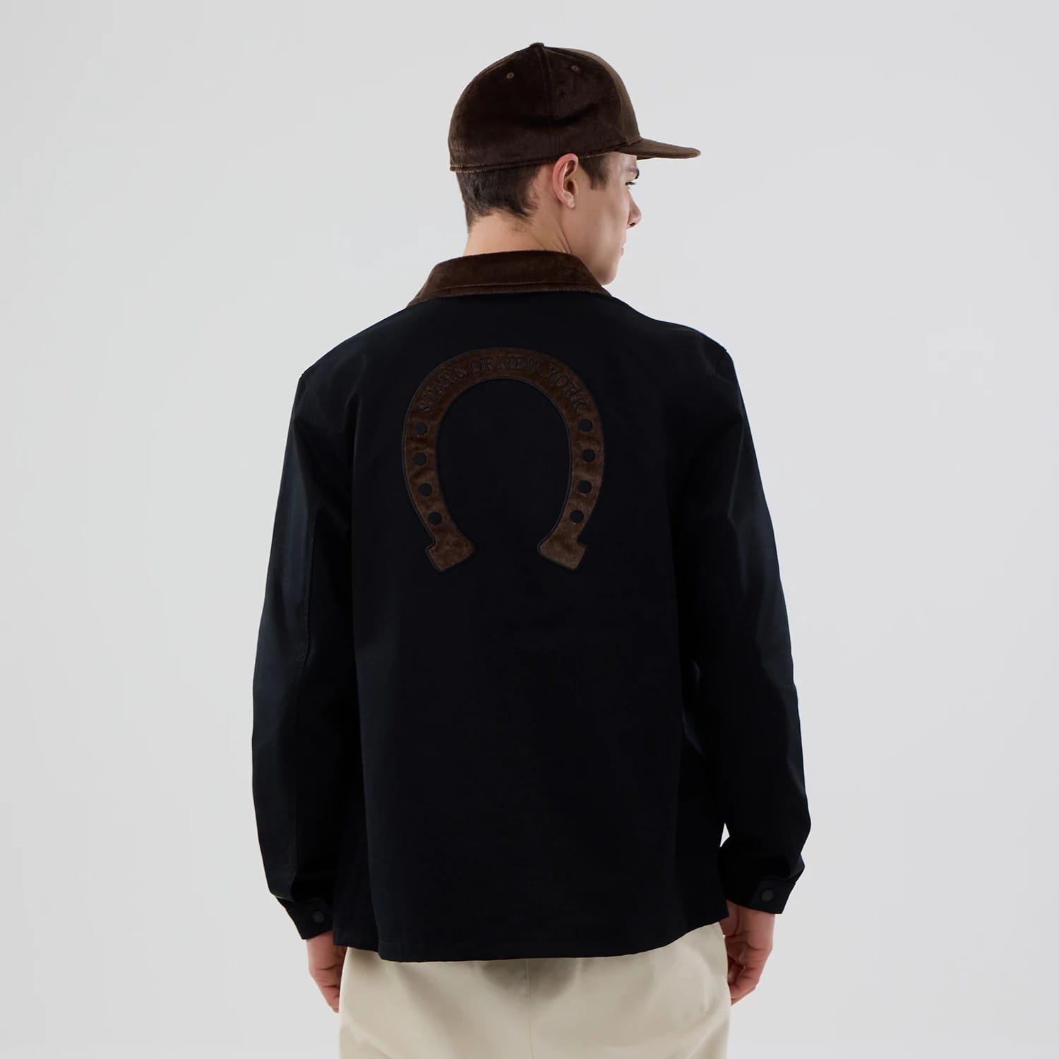 The model is wearing this New Era Year Of The Horse Jacket in black. 2