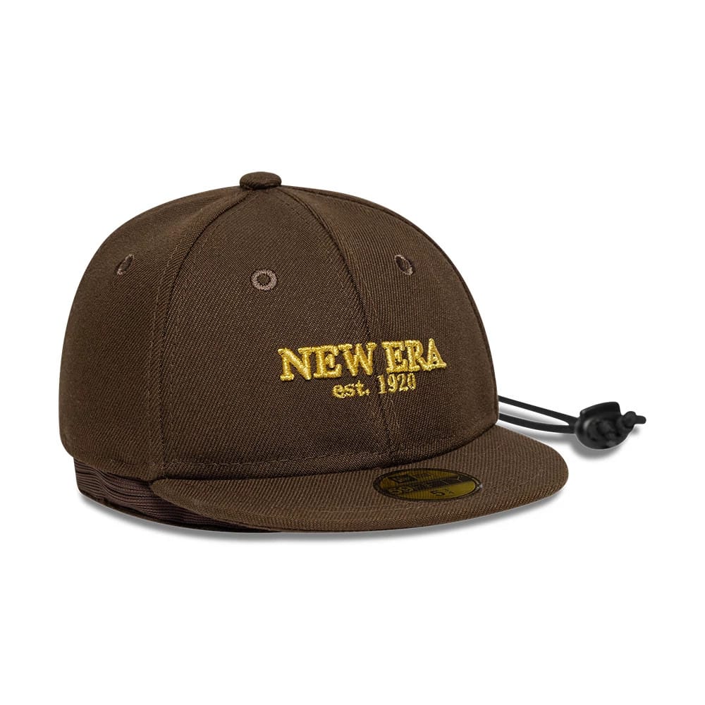 New Era Year Of The Horse Dark Brown Cap Pouch, three-quarter view showing the yellow New Era est. 1920 embroidery on the front panel, round top button and black drawstring closure attached at the rear, with a gold 59FIFTY size sticker on the visor.
