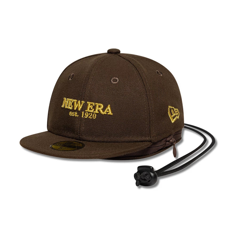 New Era Year Of The Horse Dark Brown Cap Pouch, side view showing embroidered yellow New Era lettering on the front panel, curved visor with 9FIFTY size sticker, New Era flag logo on the left side and drawstring closure at the back.