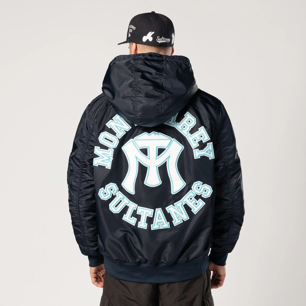 Sultanes De Monterrey LMB X Alpha Navy Jacket, rear view showing a large light blue Monterrey Sultanes logo centred on the back, contrasted against the navy fabric beneath a raised hood.