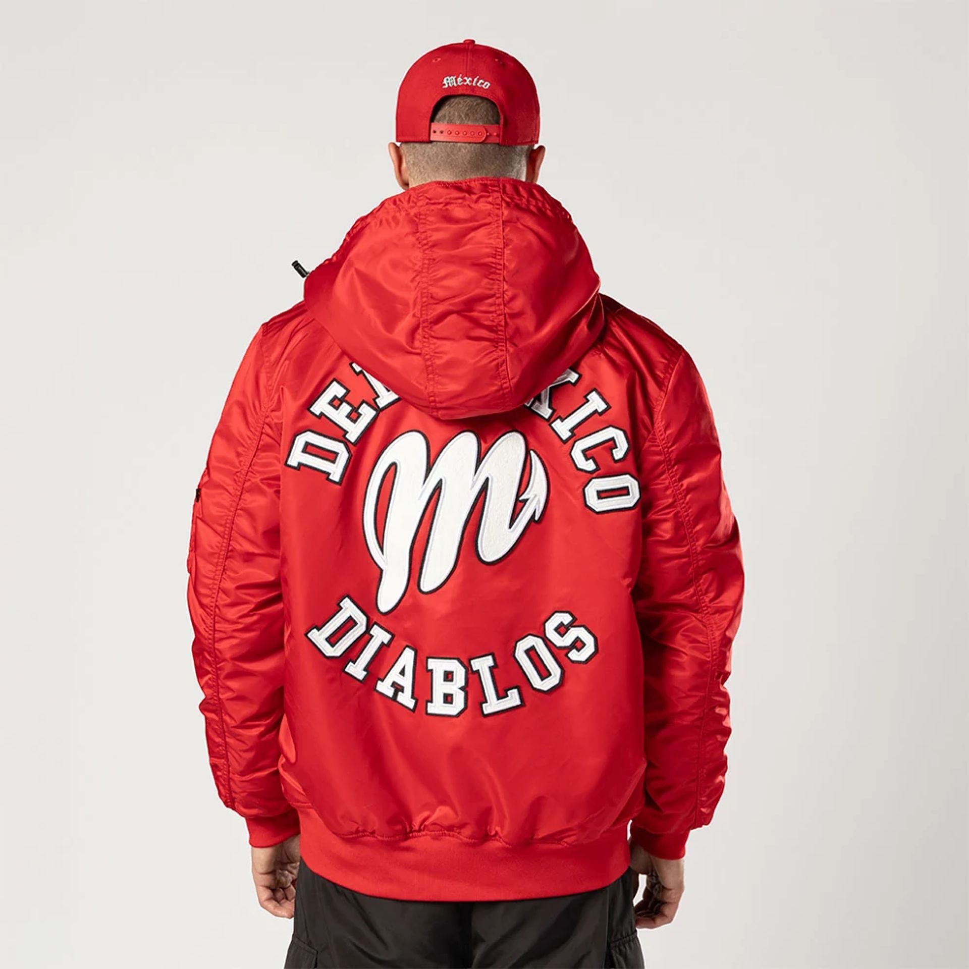 The Male model is wearing Mexico Diablos LMB X Alpha Red Jacket 2