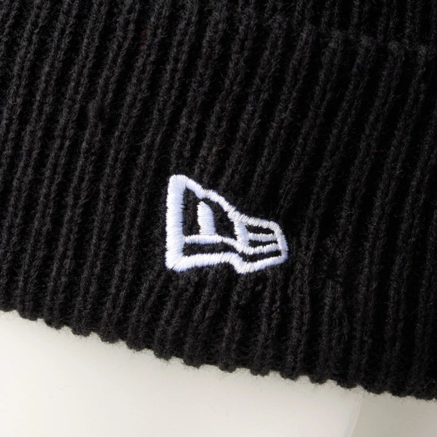 This is a New Era Black Rib Knit Beanie Hat 6