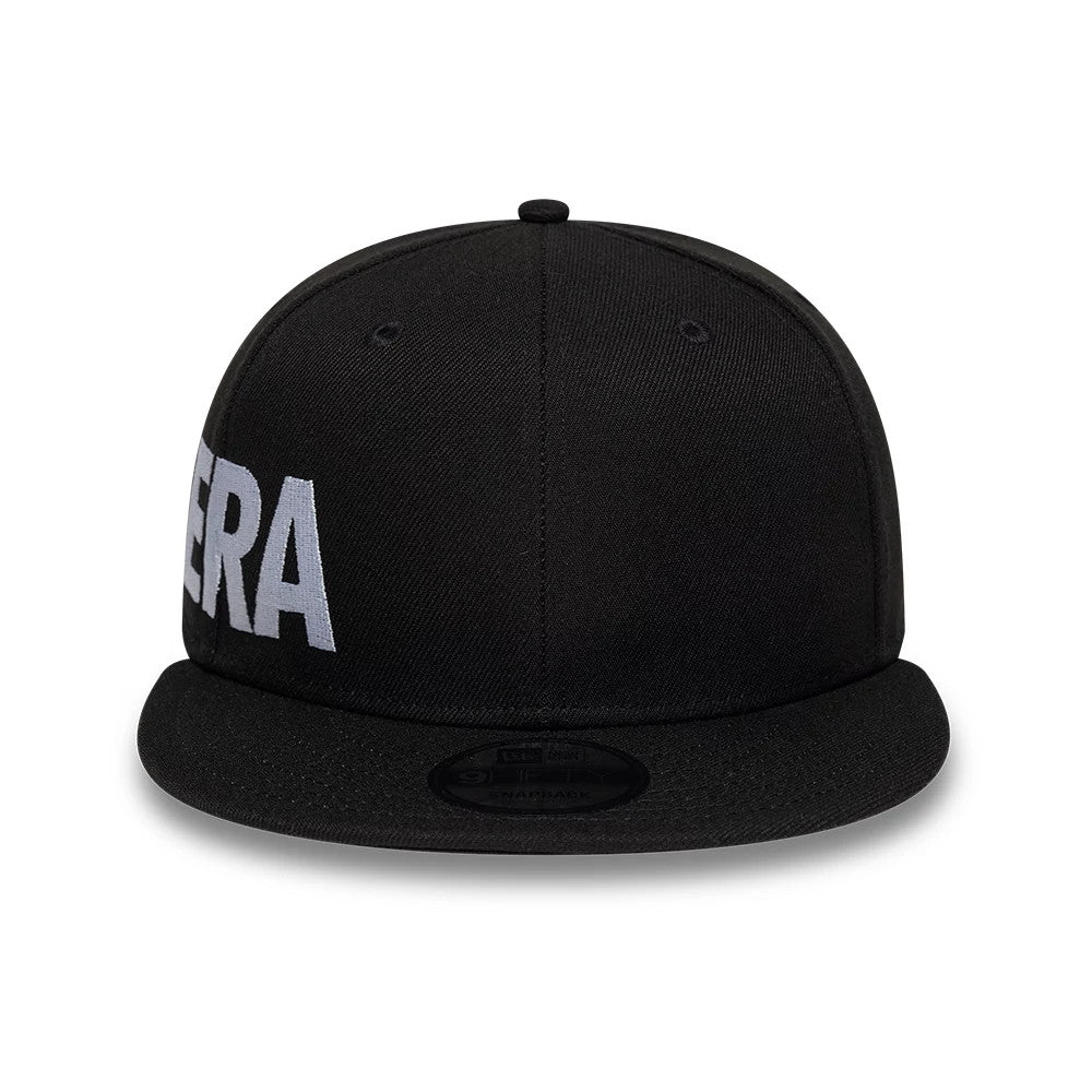 New Era Essential Black 9FIFTY Snapback Adjustable Cap, front view showing large white embroidered letters across the front panels, with a black flat visor and a 9FIFTY size sticker on top.