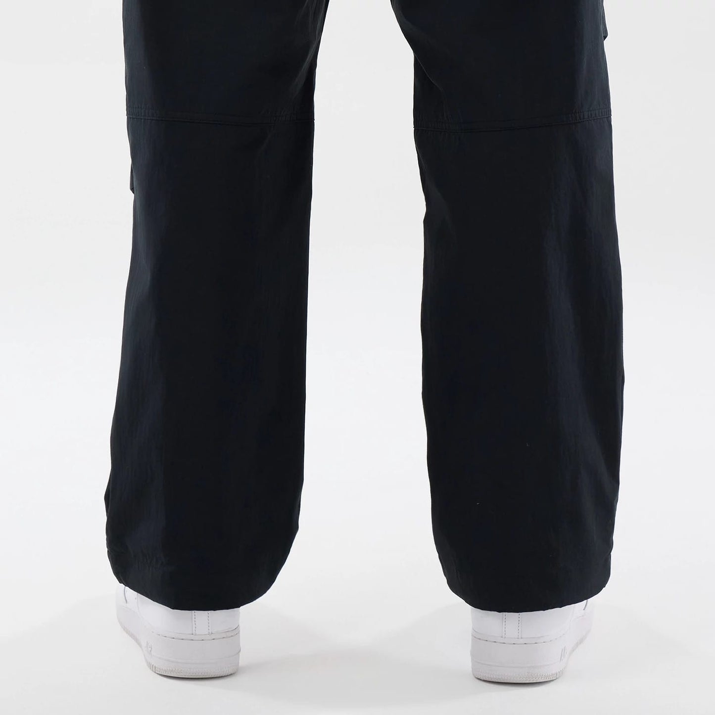 The Male model is wearing New Era Organic Black Parachute Trousers 7