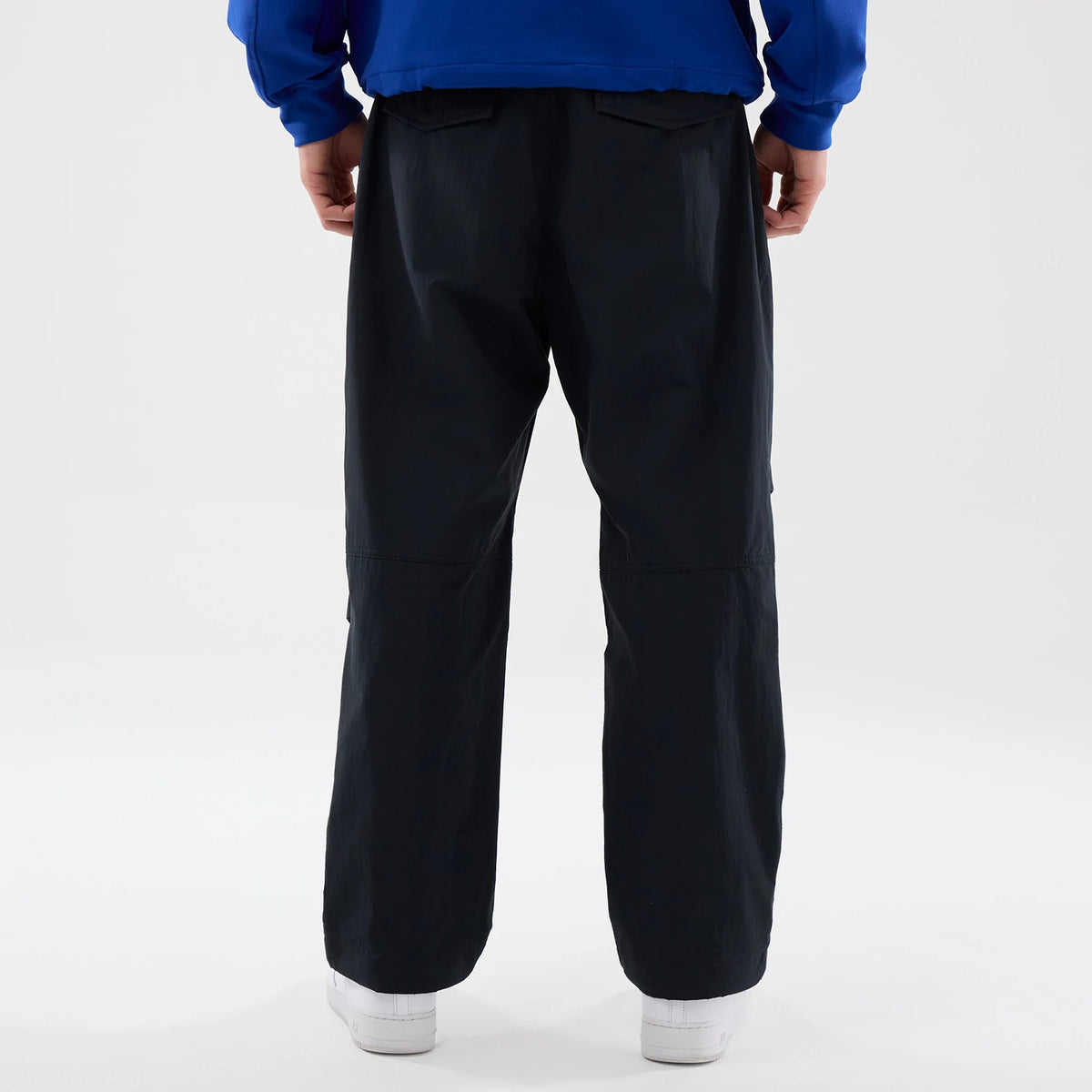 The Male model is wearing New Era Organic Black Parachute Trousers 2