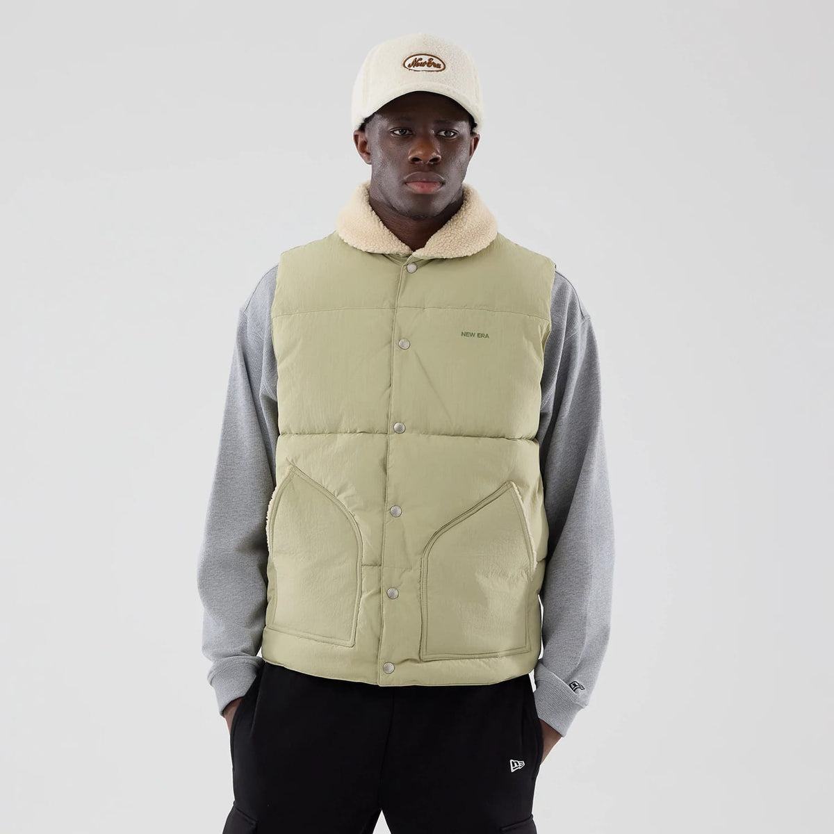 The Male model is wearing New Era Organic Boa Neck Khaki Gilet 3