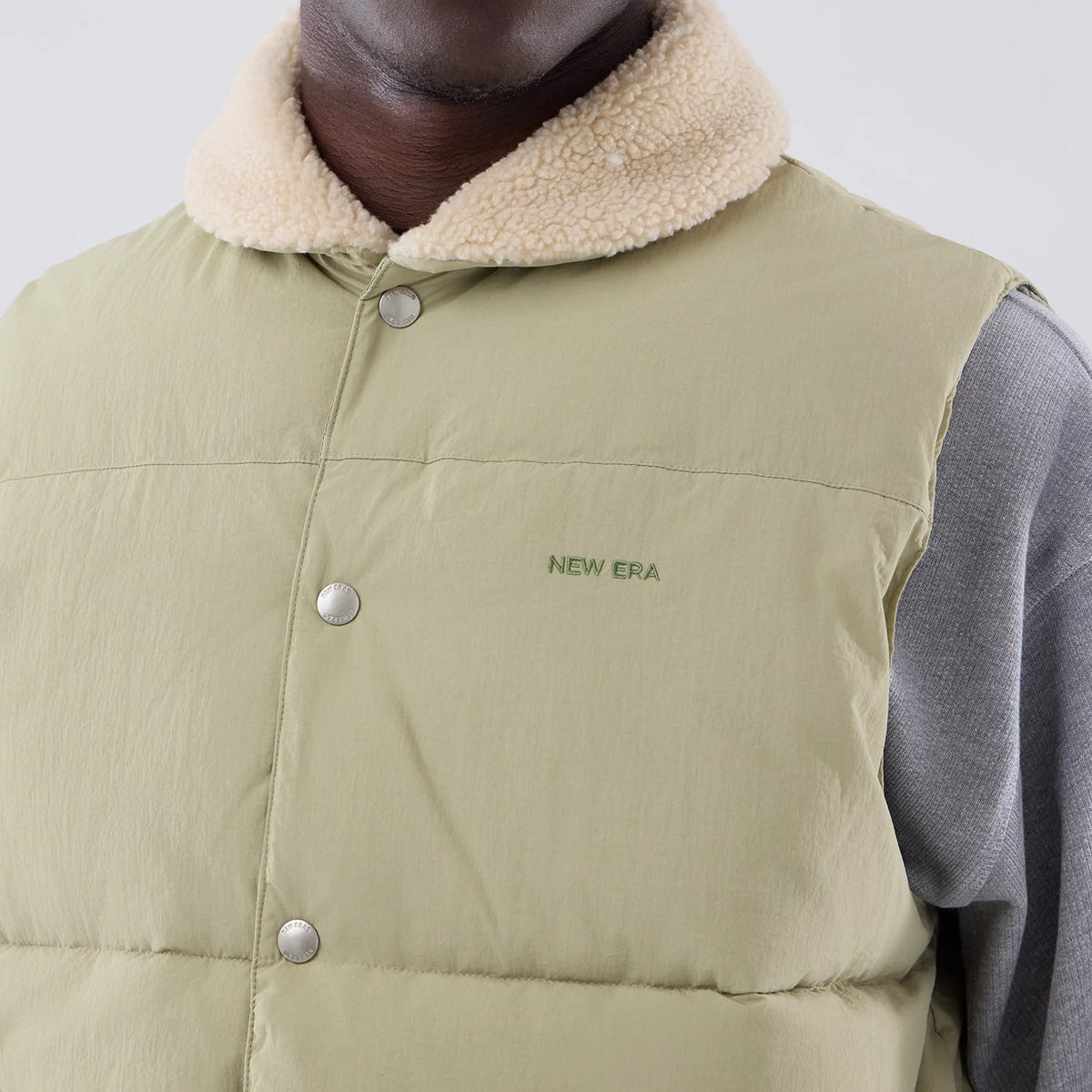 The Male model is wearing New Era Organic Boa Neck Khaki Gilet 4