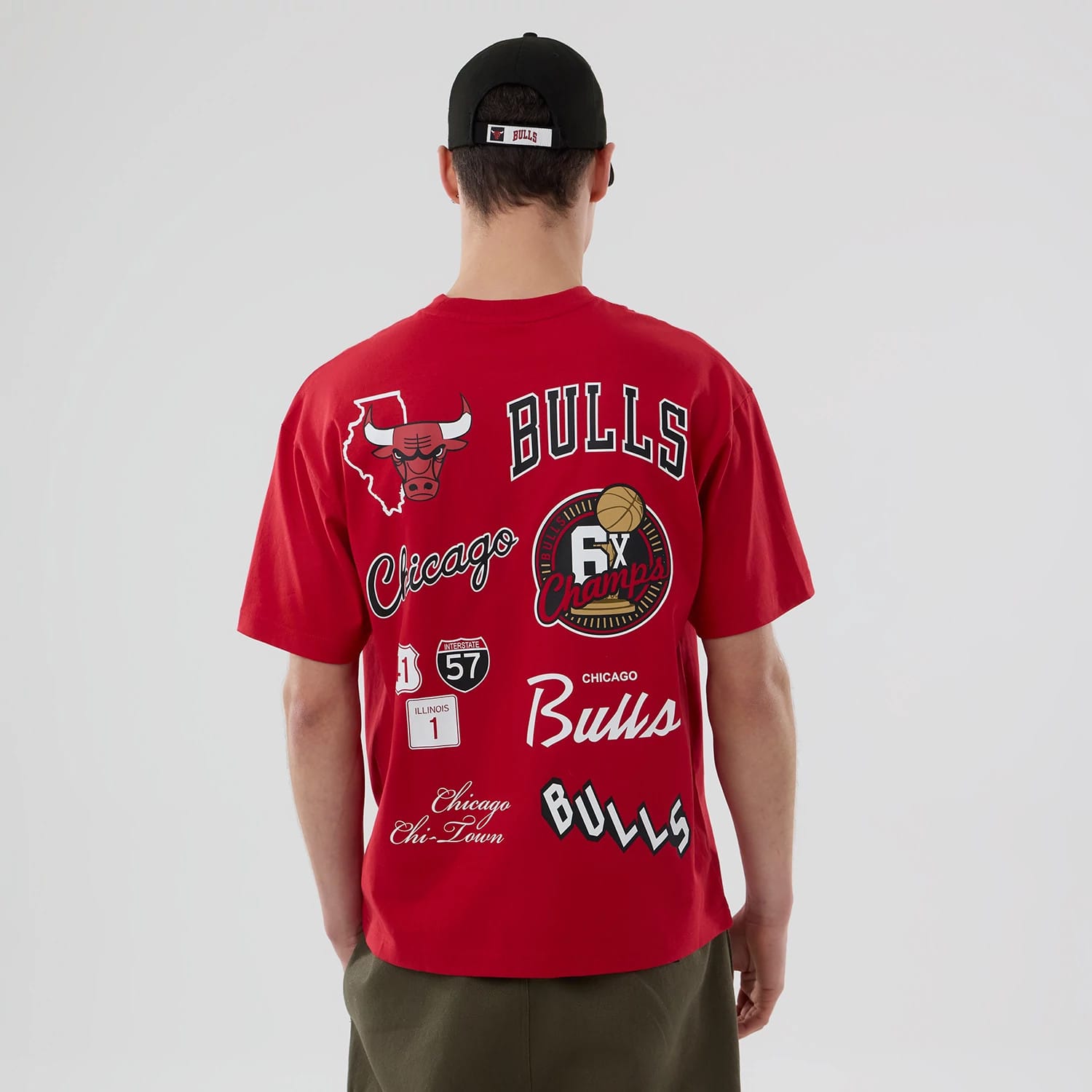 Chicago Bulls NBA logo Red T-Shirt, rear view showing various printed graphics including the Bulls logo, "Bulls" text across the upper back, and "6x Champs" emblem alongside Illinois icons on the red fabric.
