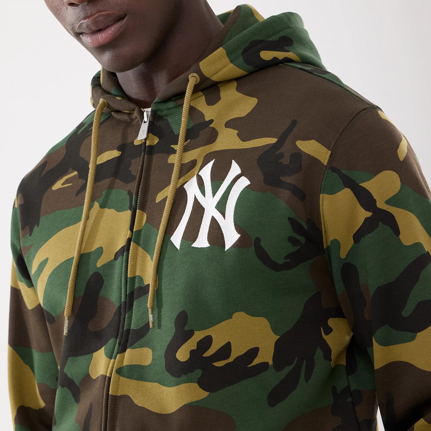 The model is wearing this MLB Camo New York Yankees 2 Way Full Zip Hoodie in Woodland Camo. 3