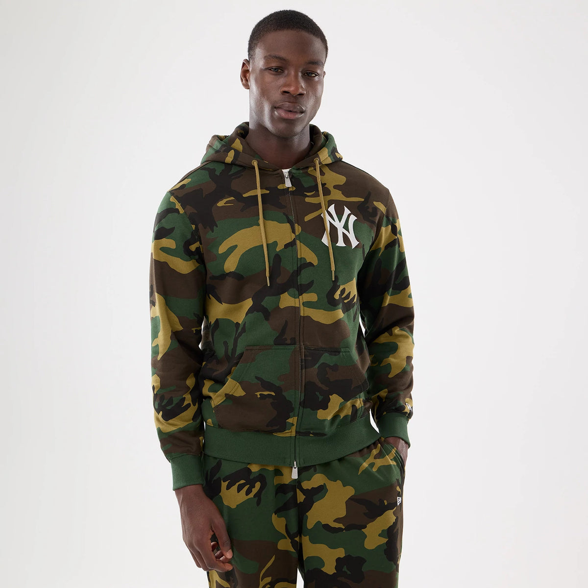 New York Yankees MLB Woodland Camo 2 Way Full Zip Hoodie, front view showing the green and brown camouflage pattern with a white New York Yankees logo on the chest and a full-length zip with drawstring hood.