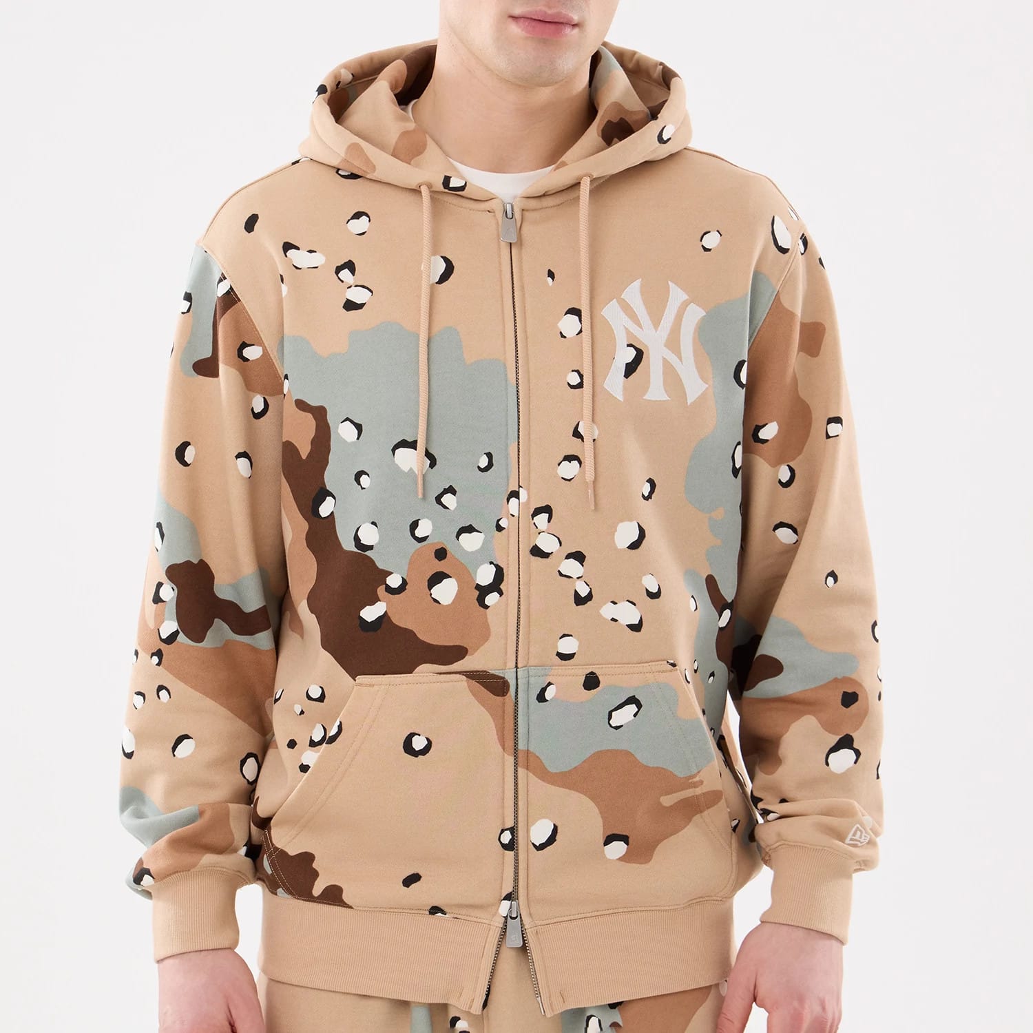 The model is wearing this MLB Camo New York Yankees 2 Way Full Zip Hoodie in Desert Camo. 3