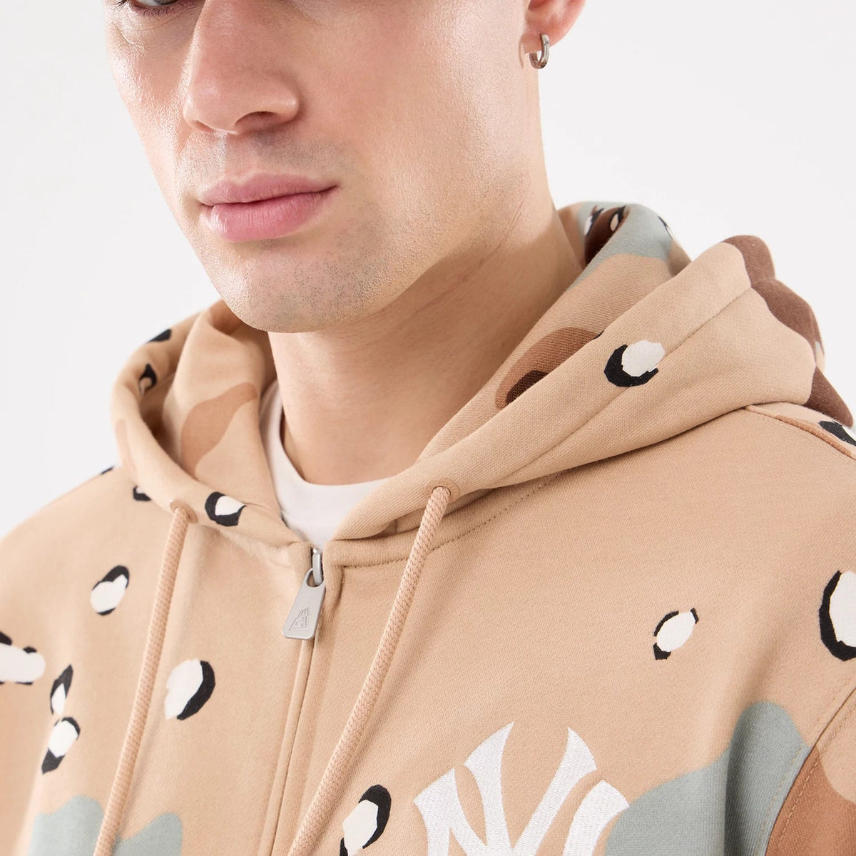 New York Yankees MLB Desert Camo 2 Way Full Zip Hoodie, front view showing a tan desert camo pattern with a white raised NY logo on the left chest and a full zip closure with tan drawstrings around the hood.