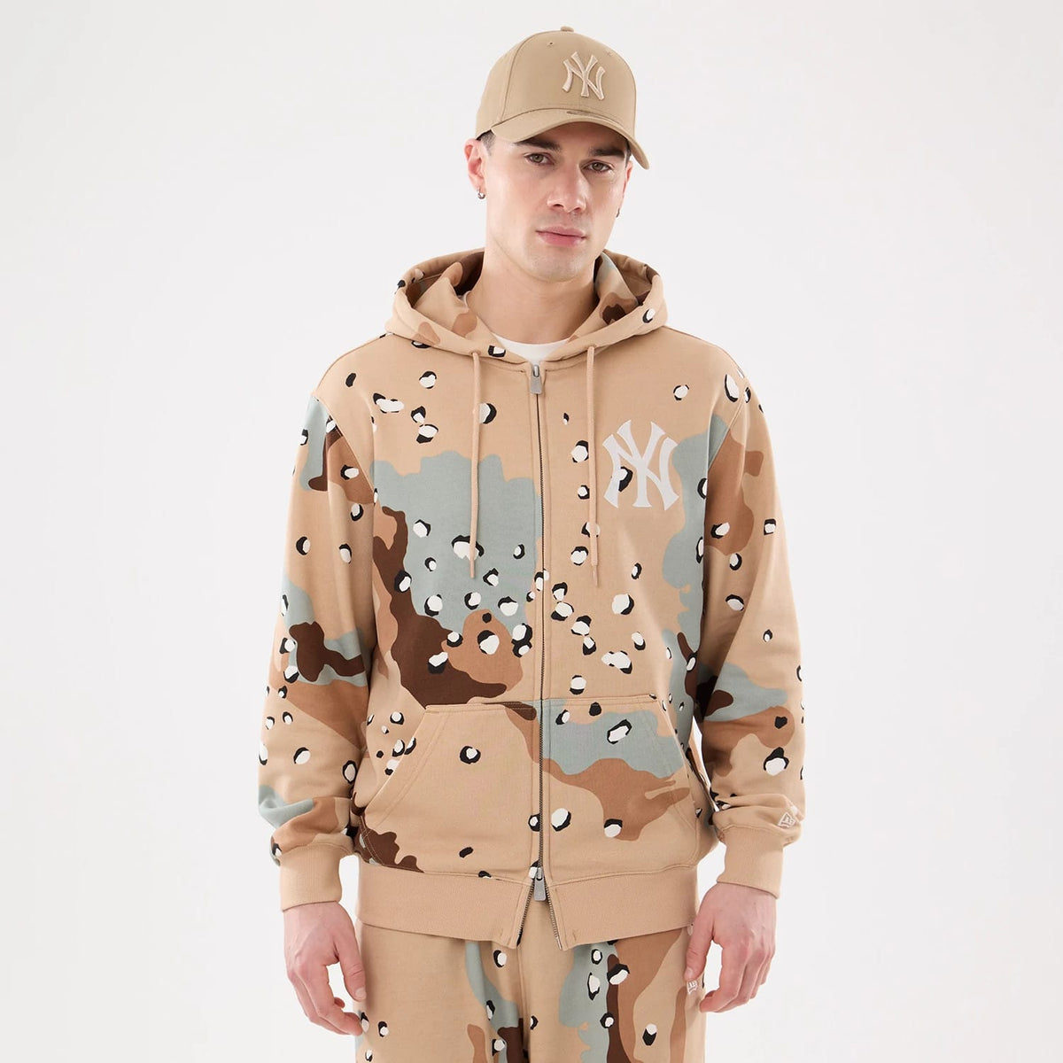 New York Yankees MLB Desert Camo 2 Way Full Zip Hoodie, front view showing the beige, brown, and green camo pattern with a white raised New York Yankees logo on the left chest and a full zip closure down the centre.
