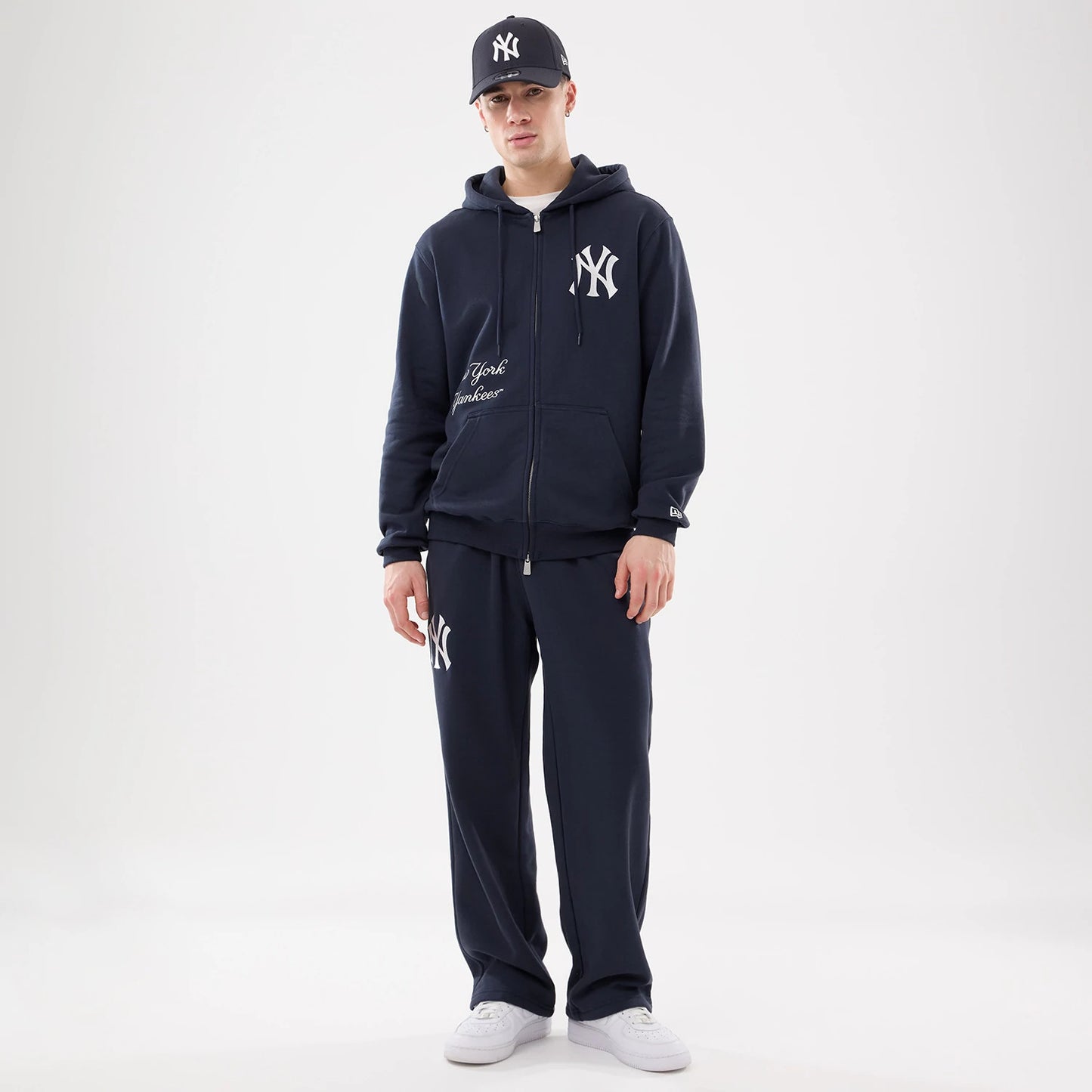 The model is wearing this MLB Comfort New York Yankees 2 Way Full Zip Hoodie in navy. 8