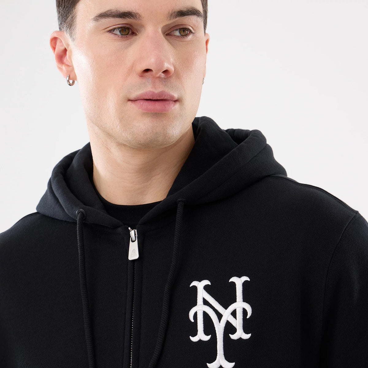New York Mets MLB Comfort Black 2 Way Full Zip Hoodie, on-model view showing the embroidered white New York Mets logo on the left chest, a full zip closure in the centre, and a black drawstring hood.