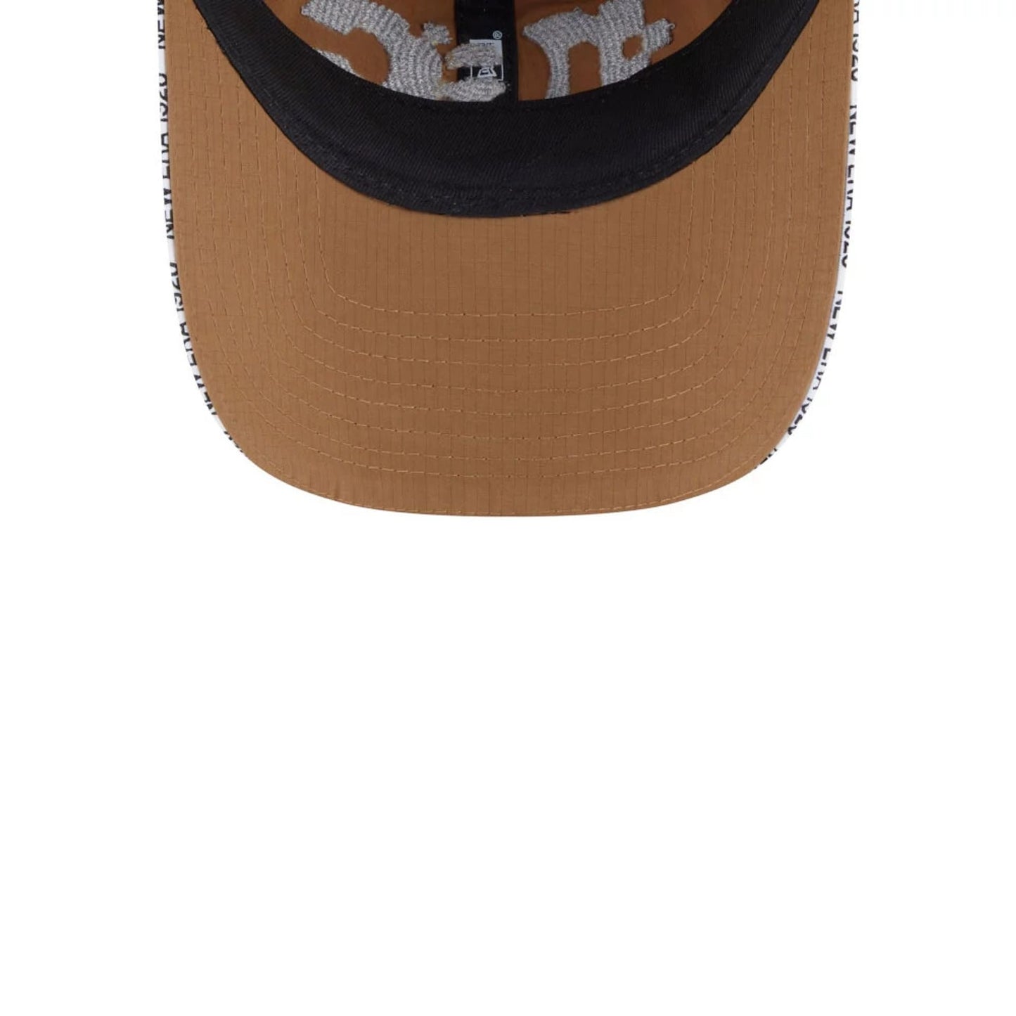 New Era NEC Logo Beige New Era 9FORTY Unstructured Adjustable Cap, inside view showing black undervisor, internal taping with New Era lettering, and contrast white stitching detail around the beige visor edge.